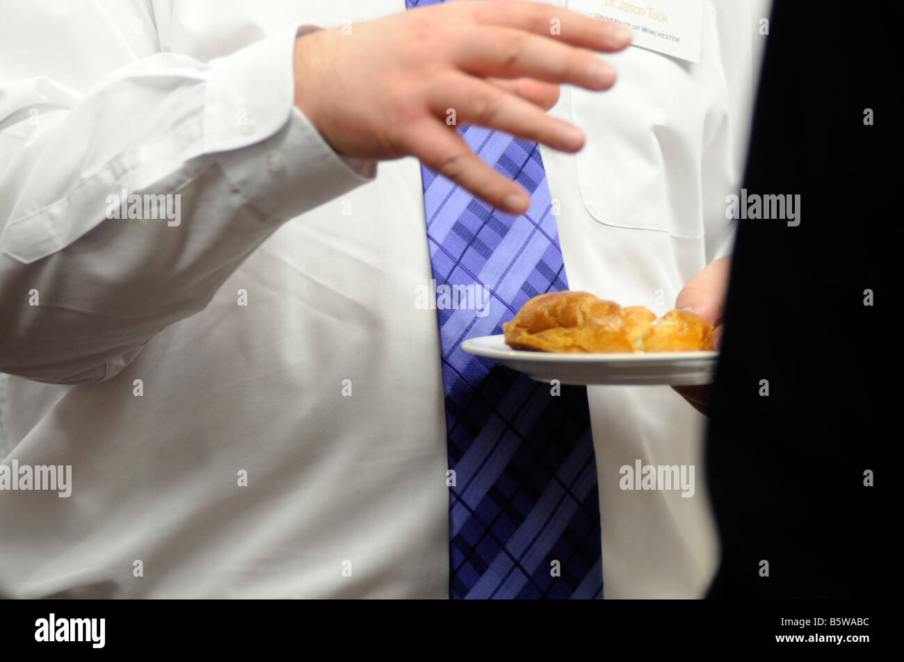 Royalty free photograph of overweight business man eating an unhealthy meal at a meeting in a hotel in London UK Stock Photo
