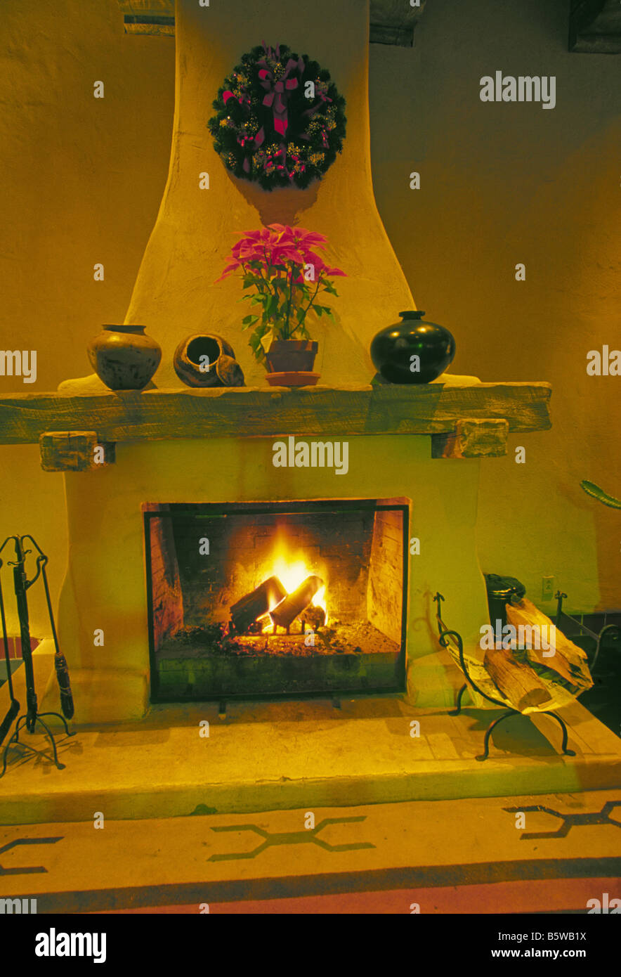 adobe fireplace decorated with Indian pottery and flowers on Christmas