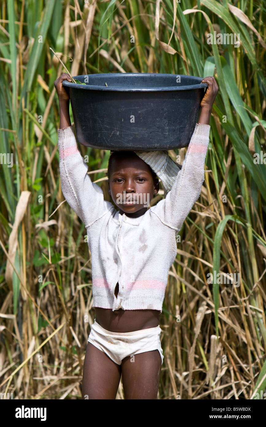 African girl with bucket of water on head, portrait Stock Photo Alamy