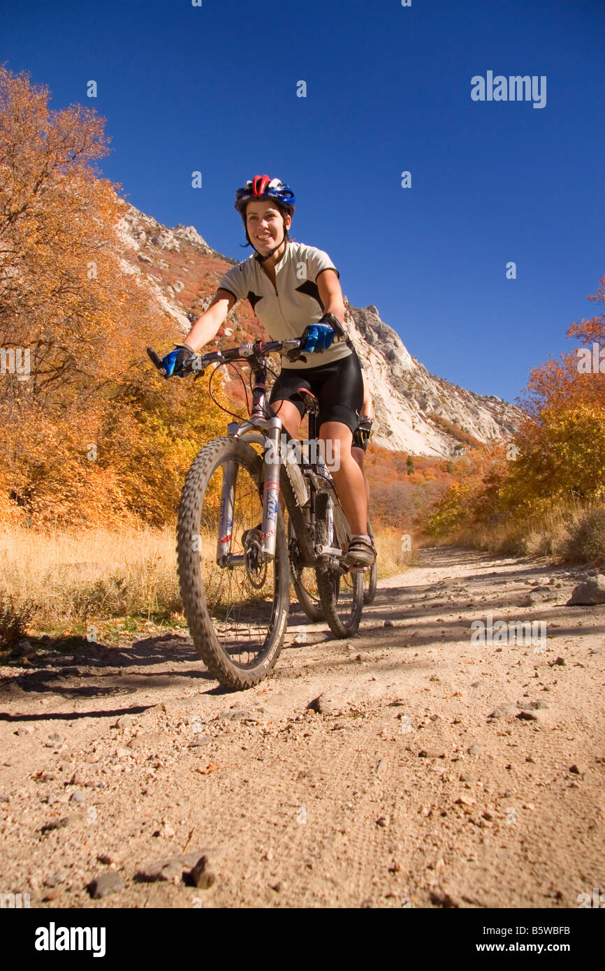 Young couple mountain biking riding amid the autumn colors on the