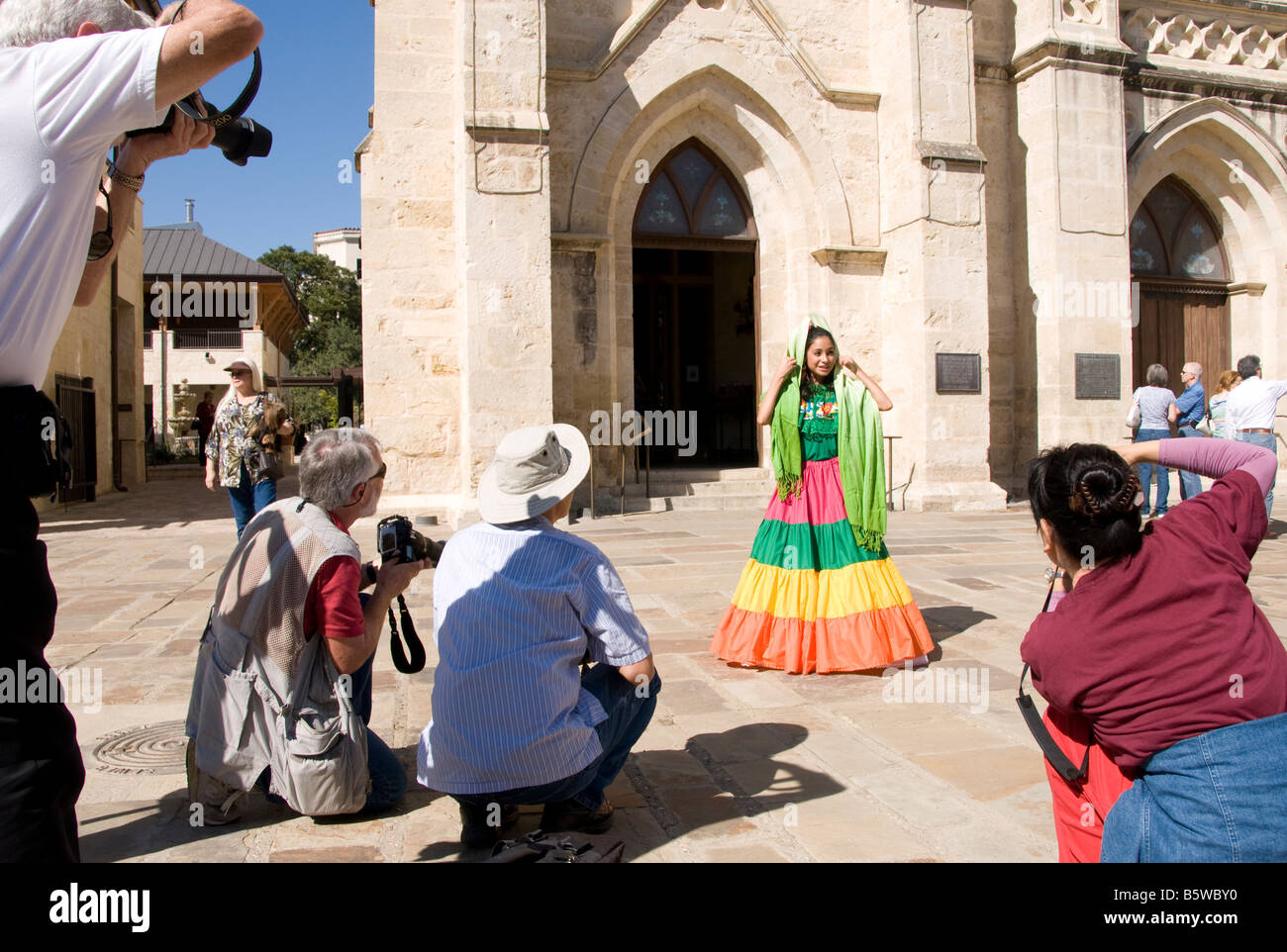 San Antonio Founder's Day young Hispanic woman in traditional dress being photographed in San Fernando Cathedral Plaza Stock Photo