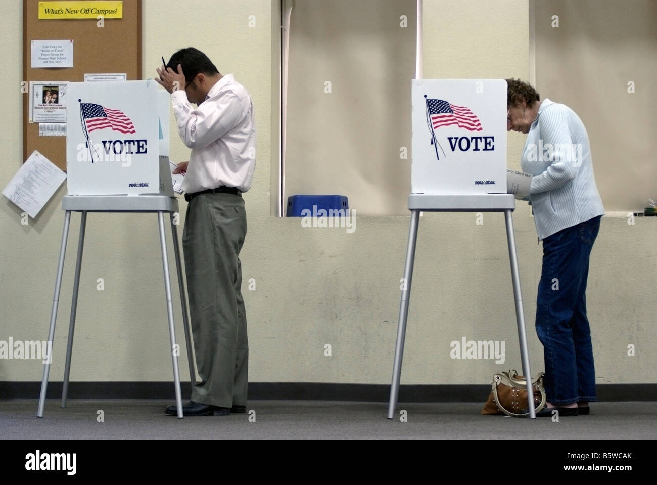 Young man and elderly woman voting at a Polling Place in San Jose, CA, on Nov. 4, during the 2008 U.S. Presidential election. Stock Photo