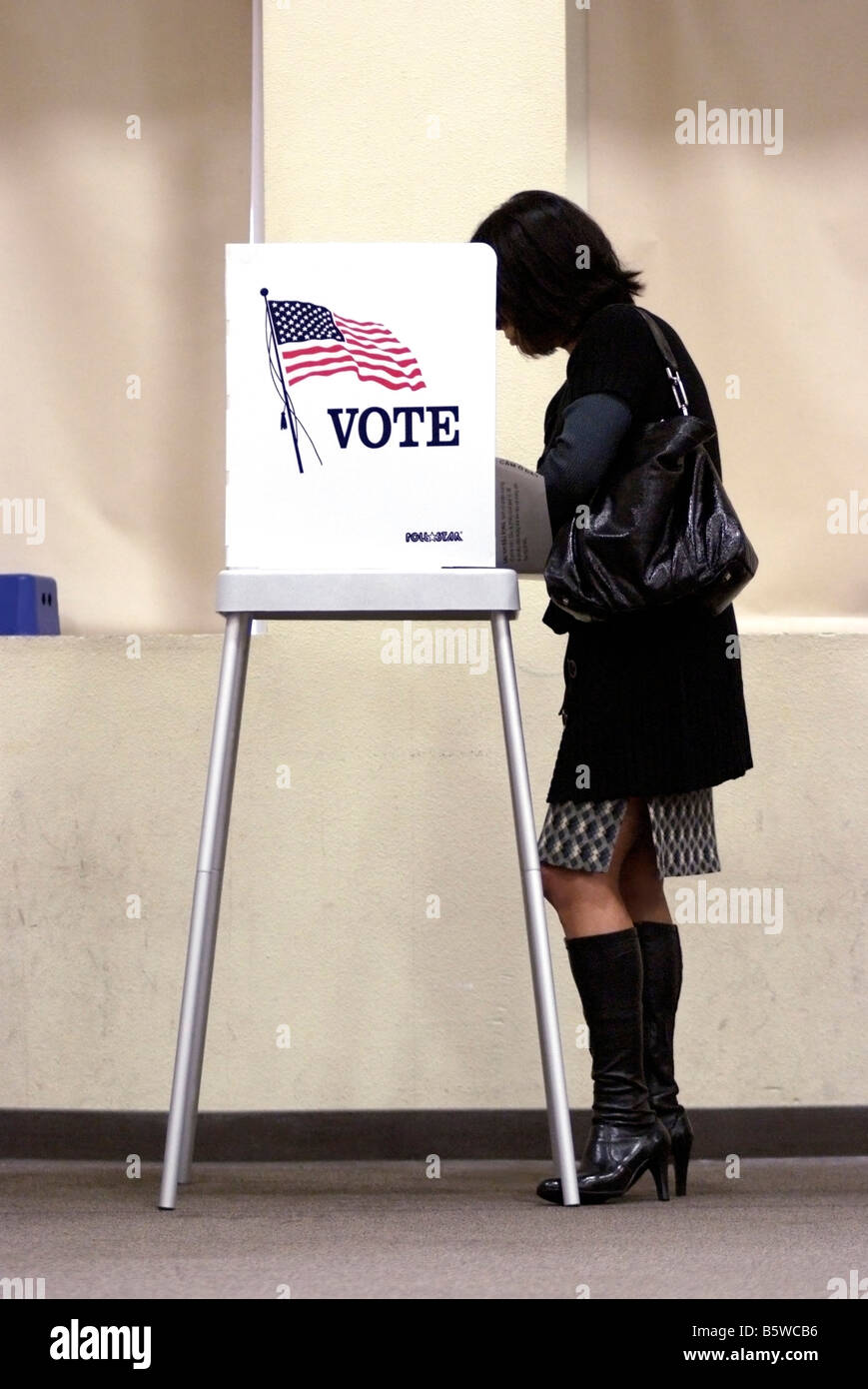 Young woman marking her ballot at Polling Place in San Jose, CA, on November 4, during the 2008 U.S. Presidential election. Stock Photo