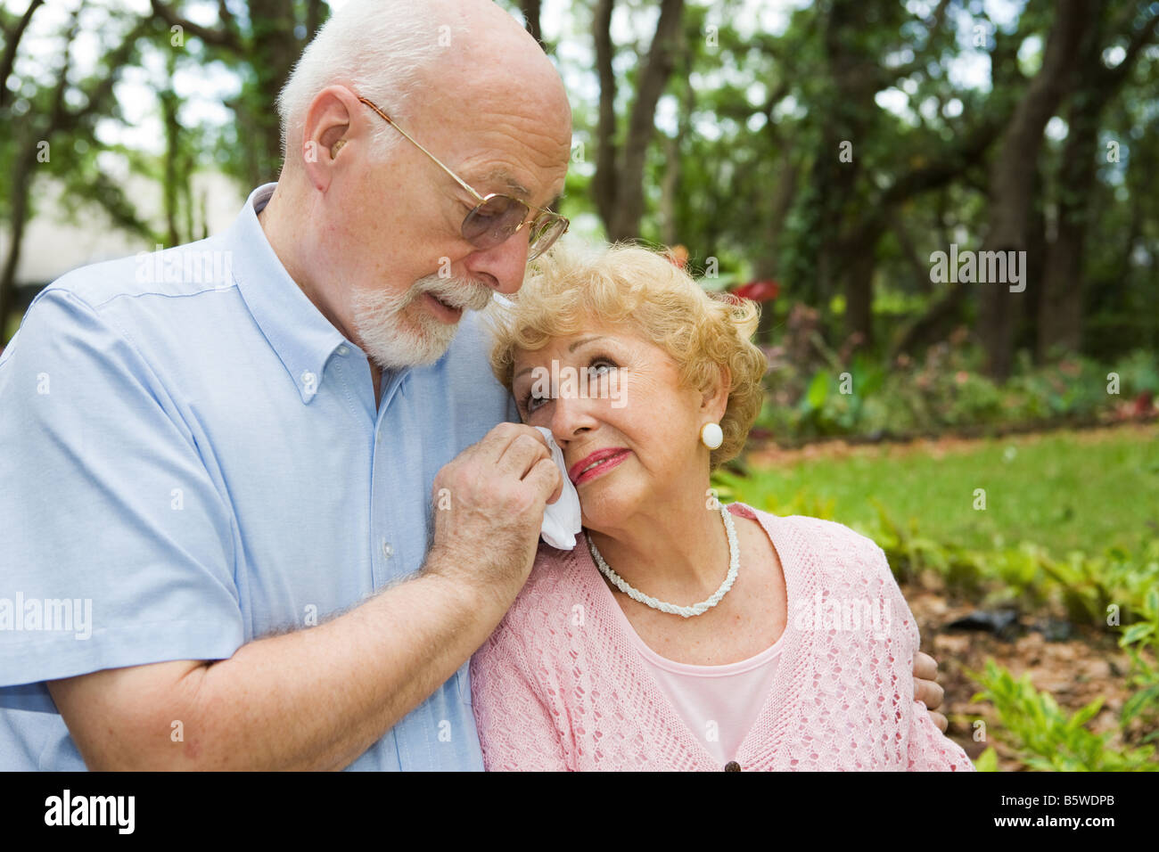 Sad senior couple in grieving the loss of a loved one Stock Photo