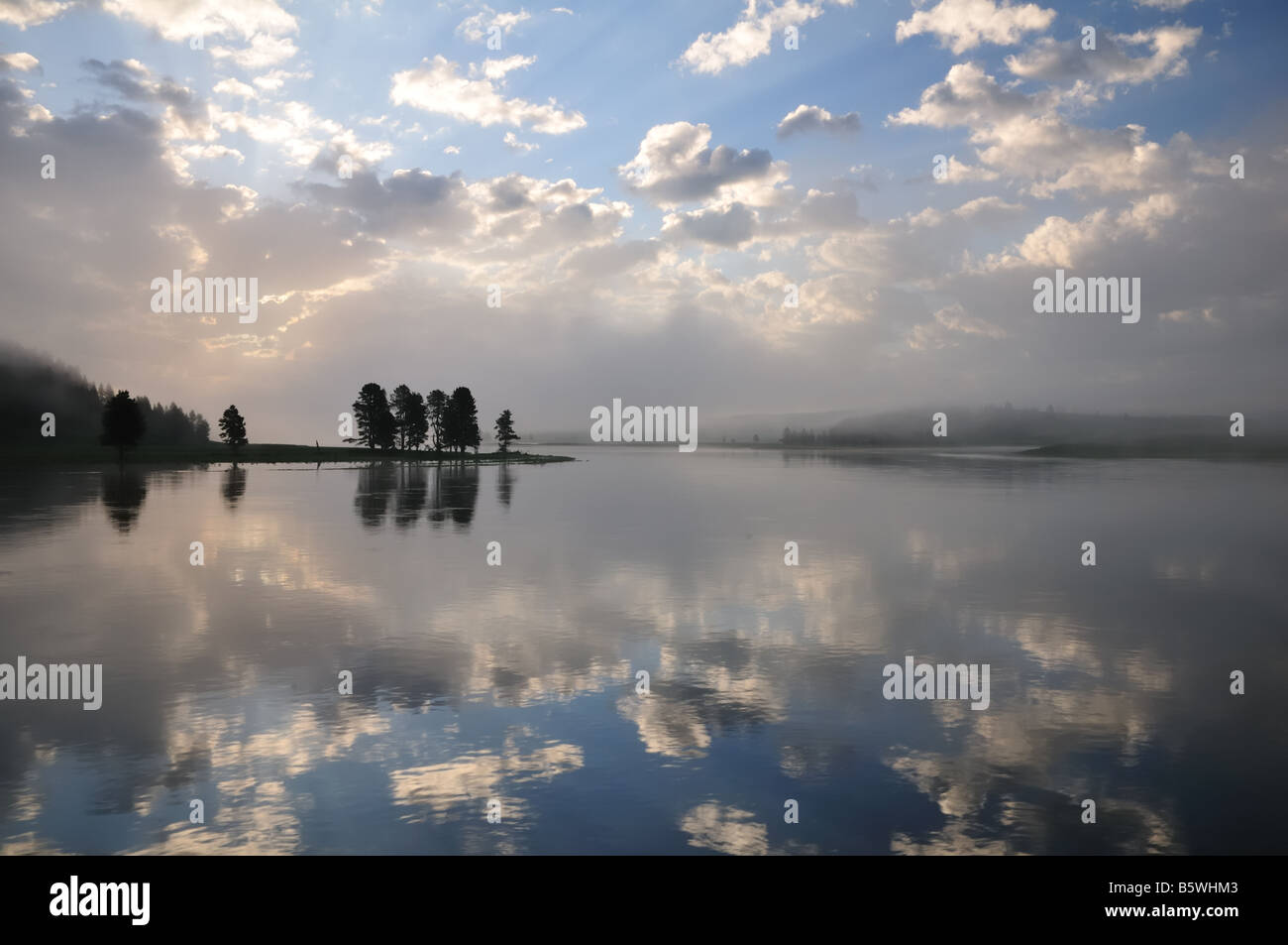 Yellowstone Rising Sun Sun rising through the clouds over a bend in the Yellowstone River ...