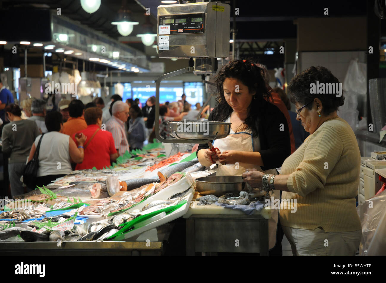 Two women prepare fish at the market in Palma, Mallorca Stock Photo
