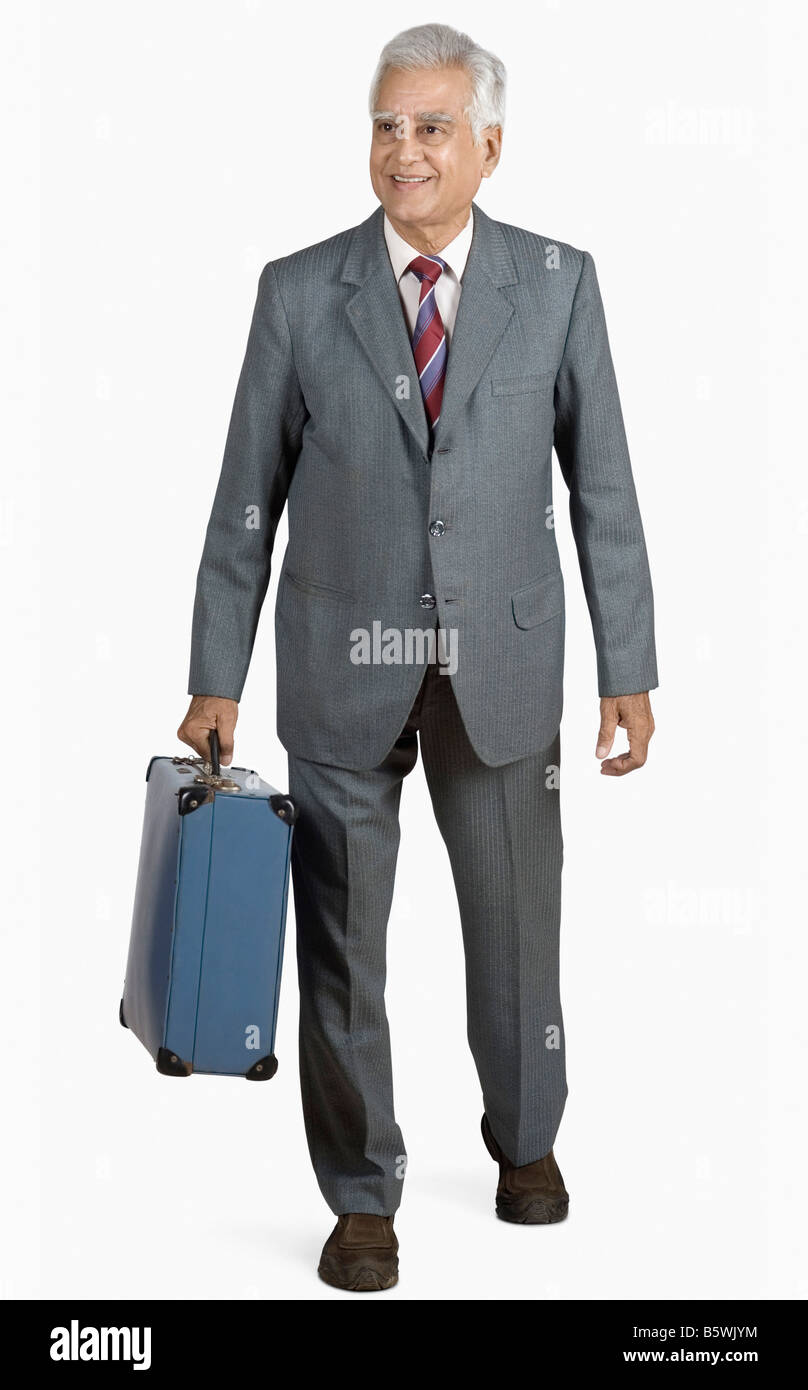 Businessman carrying a suitcase Stock Photo