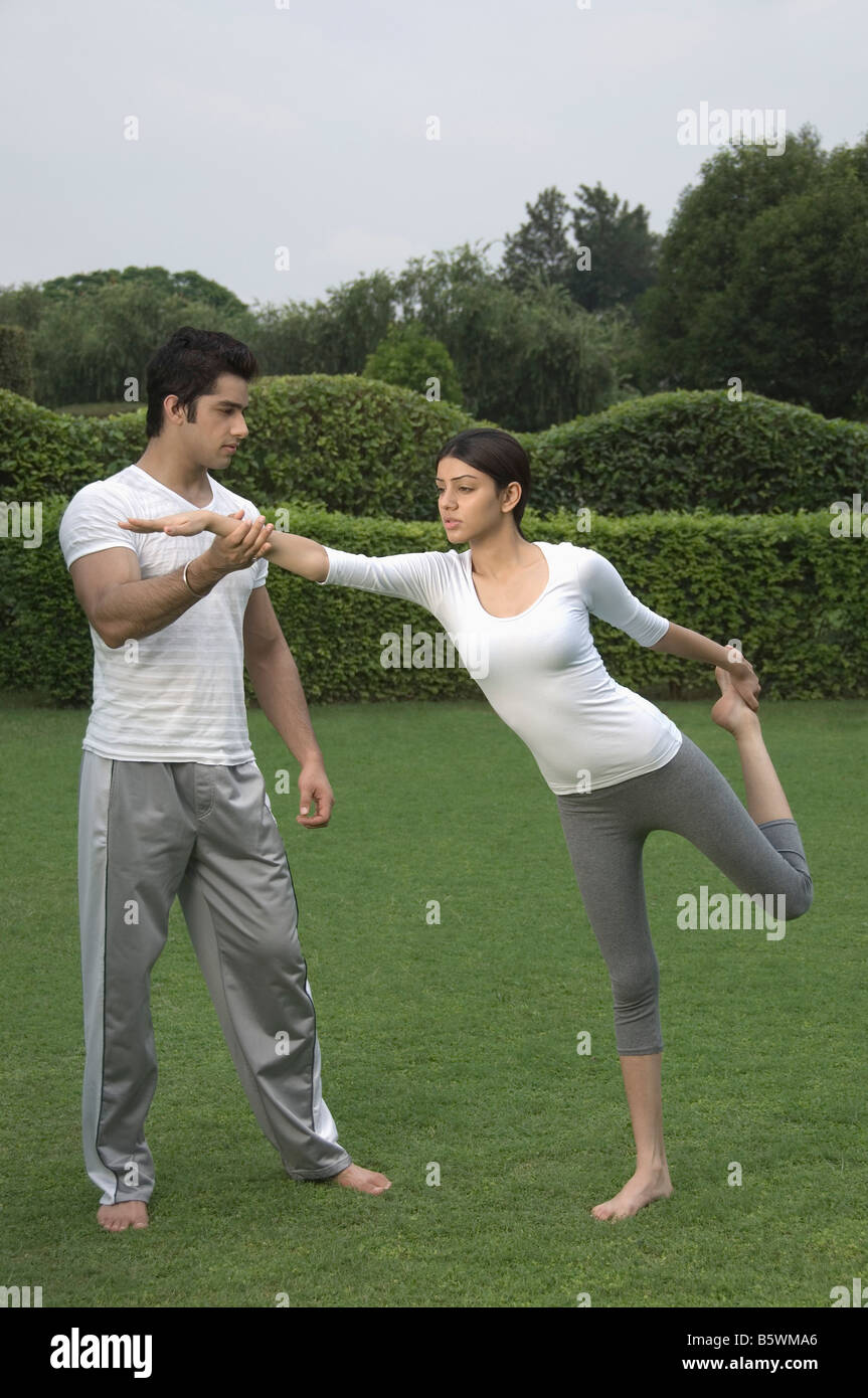 Yoga instructor teaching yoga to a woman Stock Photo