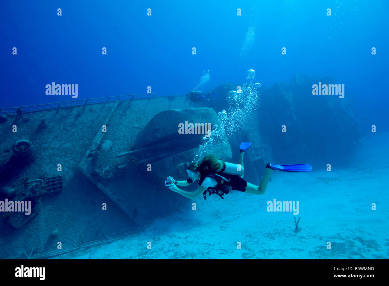 Underwater photographer and shipwreck. Stock Photo