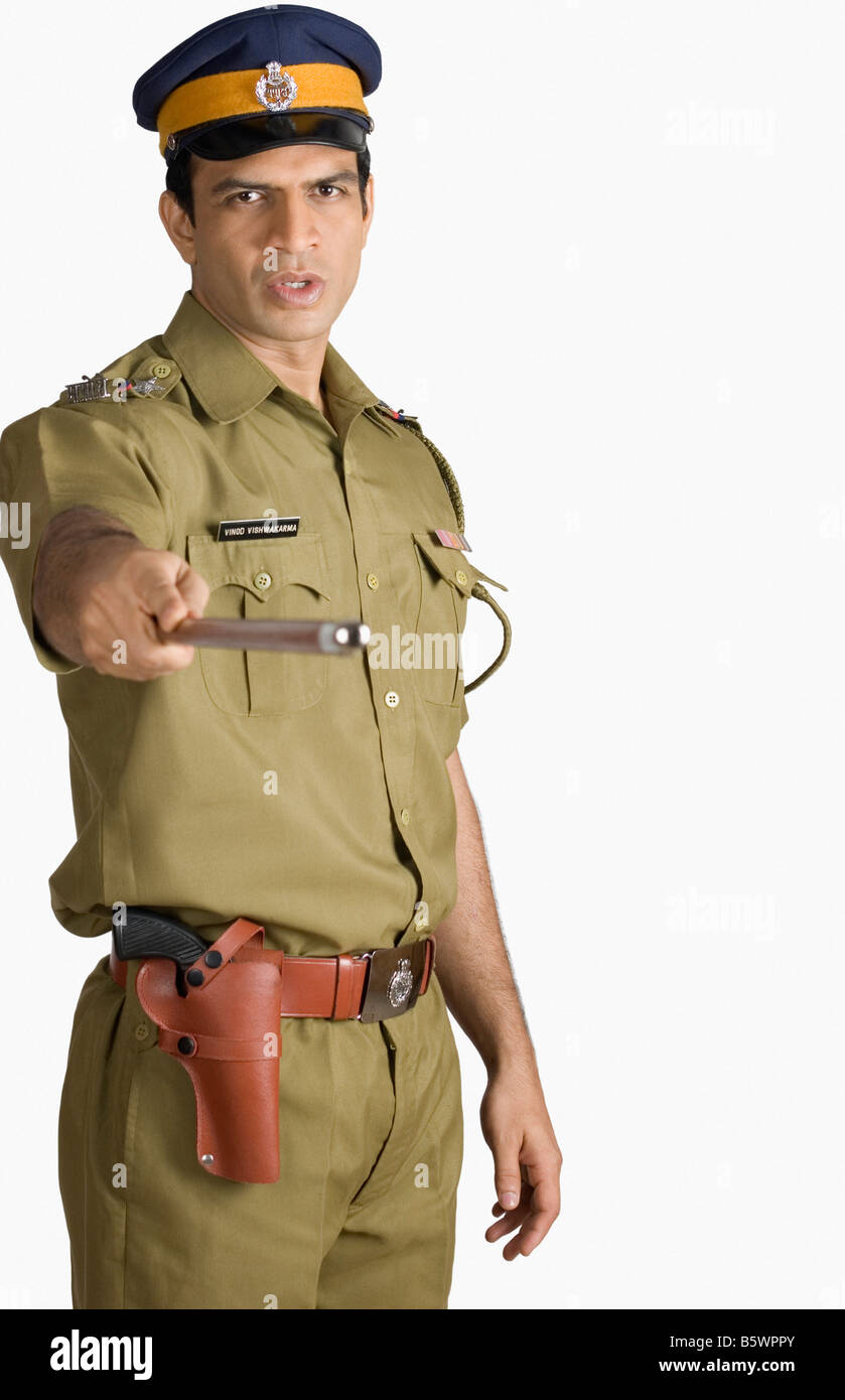 Portrait of a policeman holding a nightstick Stock Photo - Alamy