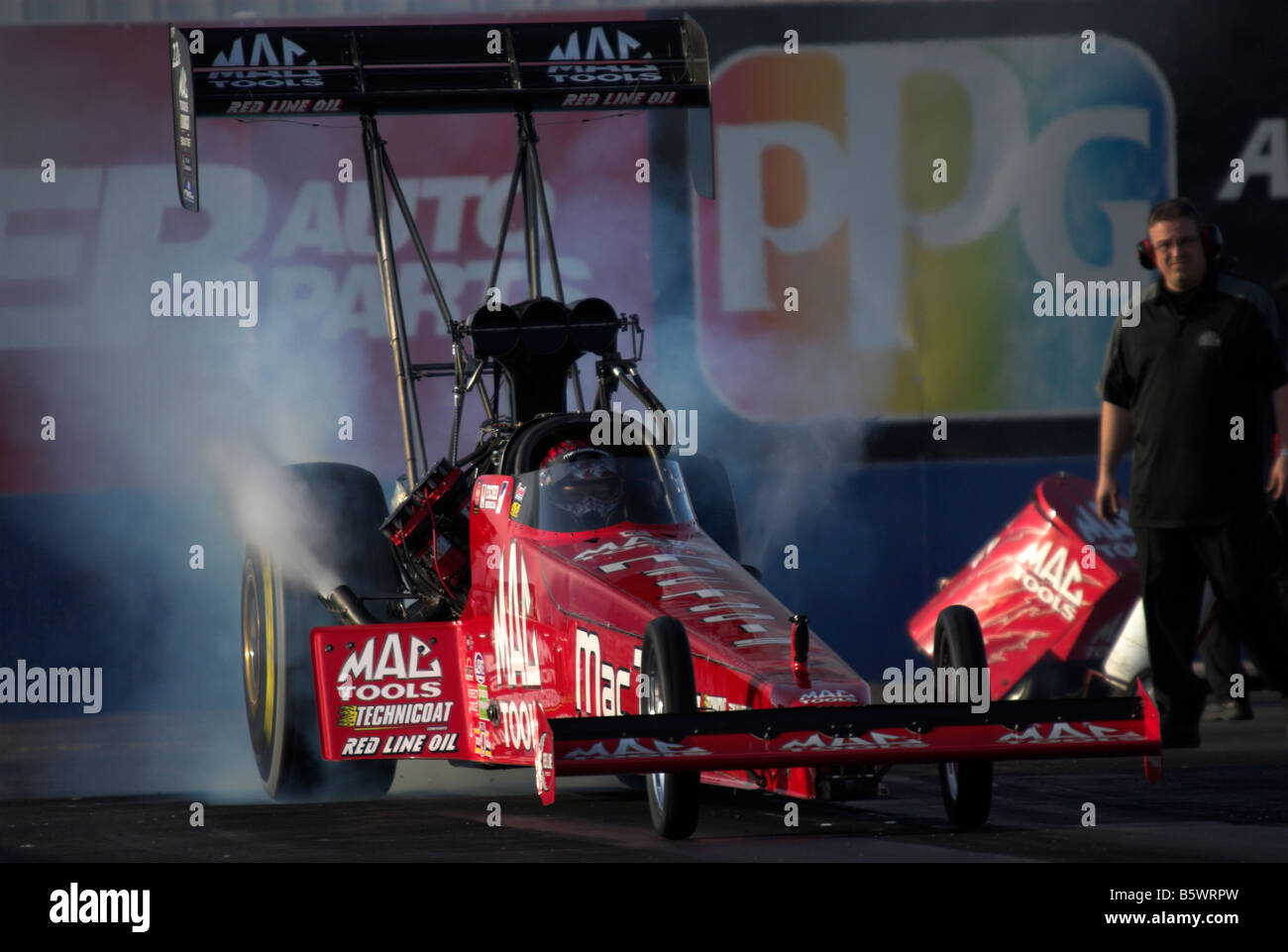 Doug Kalitta's 'Mac Tools' NHRA Top Fuel dragster - burning out at the start line. Stock Photo