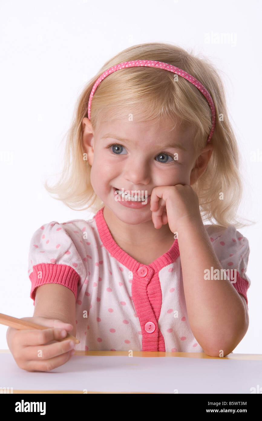 Little blond girl with a coloring pencil Stock Photo - Alamy