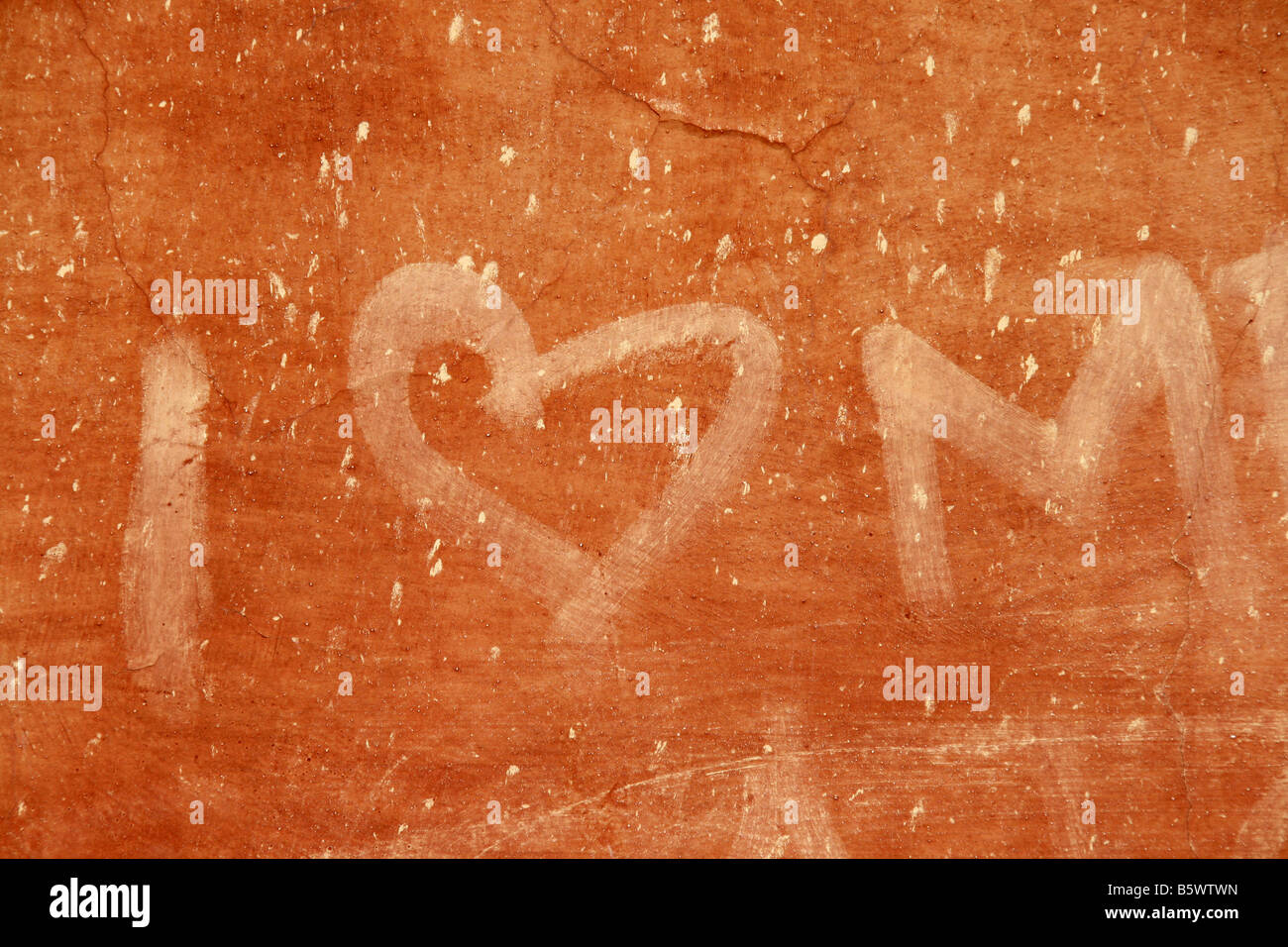 love heart graffiti on orange wall Stock Photo - Alamy