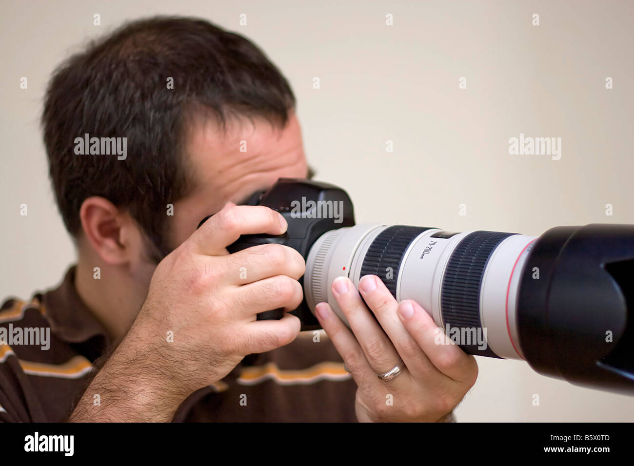 A photographer shooting with a telephoto lens Shallow depth of field Stock Photo