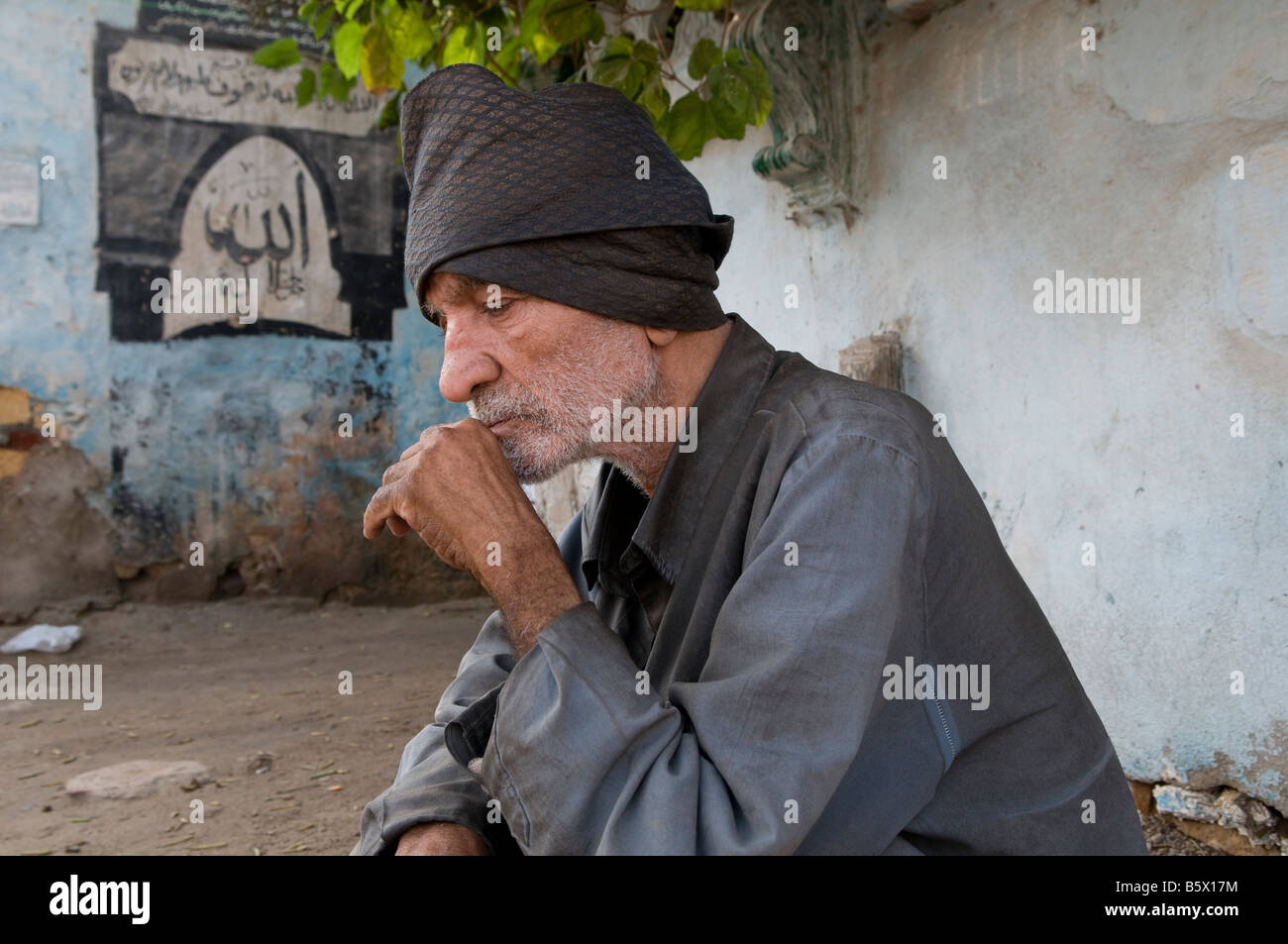 An Egyptian man in the City of the Dead or Cairo Necropolis where some people live and work amongst the dead in southeastern Cairo, Egypt. Stock Photo