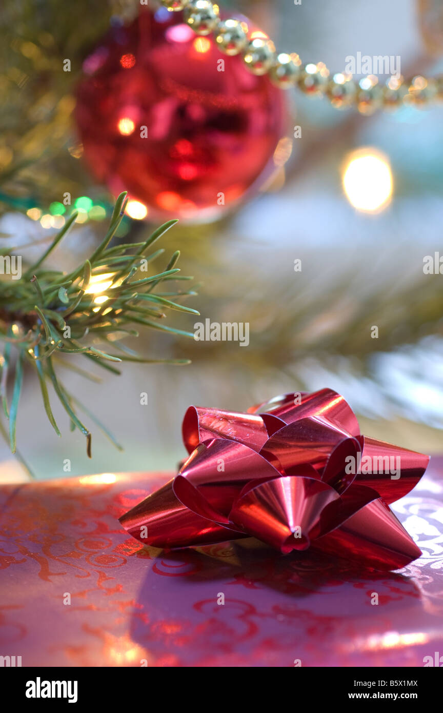 A traditional fresh pine Christmas tree with prettily wrapped gifts and