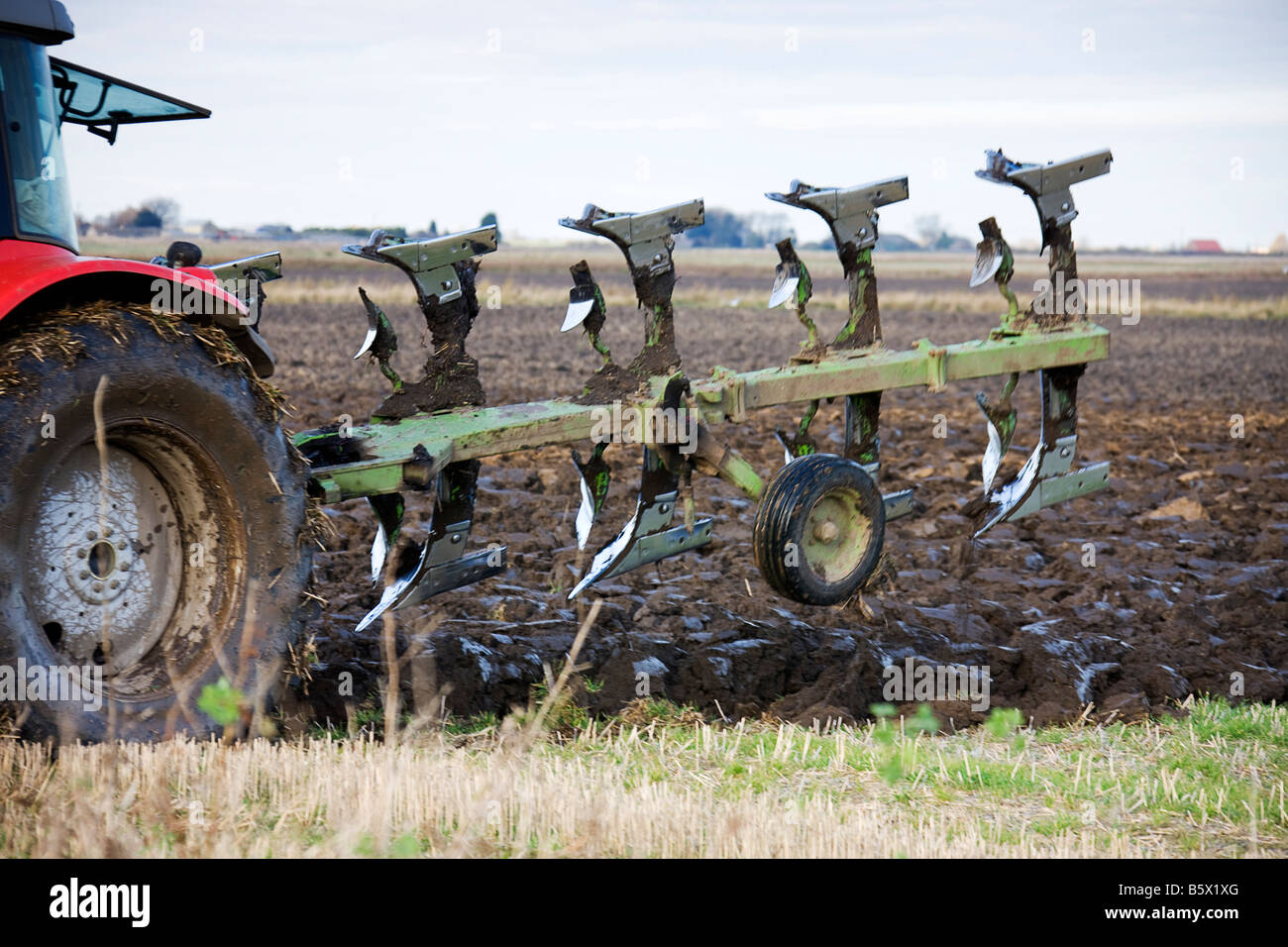 Ploughshares just lifted from the soil at the end of the row Stock