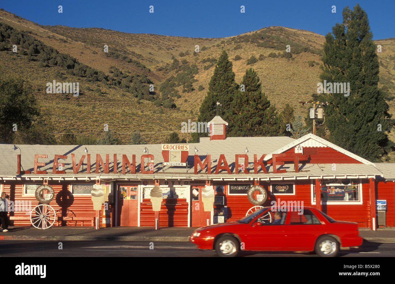 Red Car in front of a red Shop in Lee Mining California USA Stock Photo