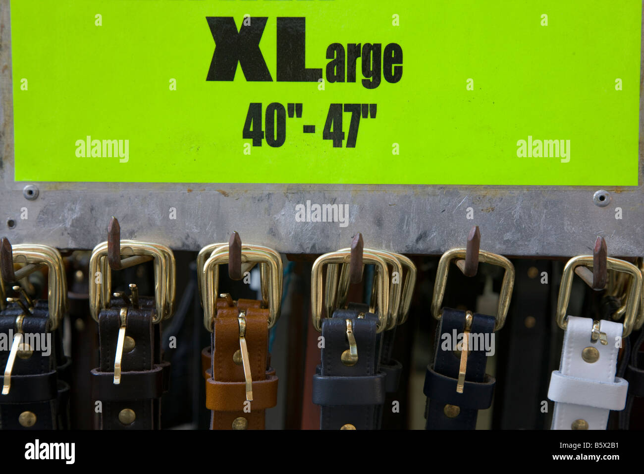 Row of XLarge leather belts on a market stall Stock Photo