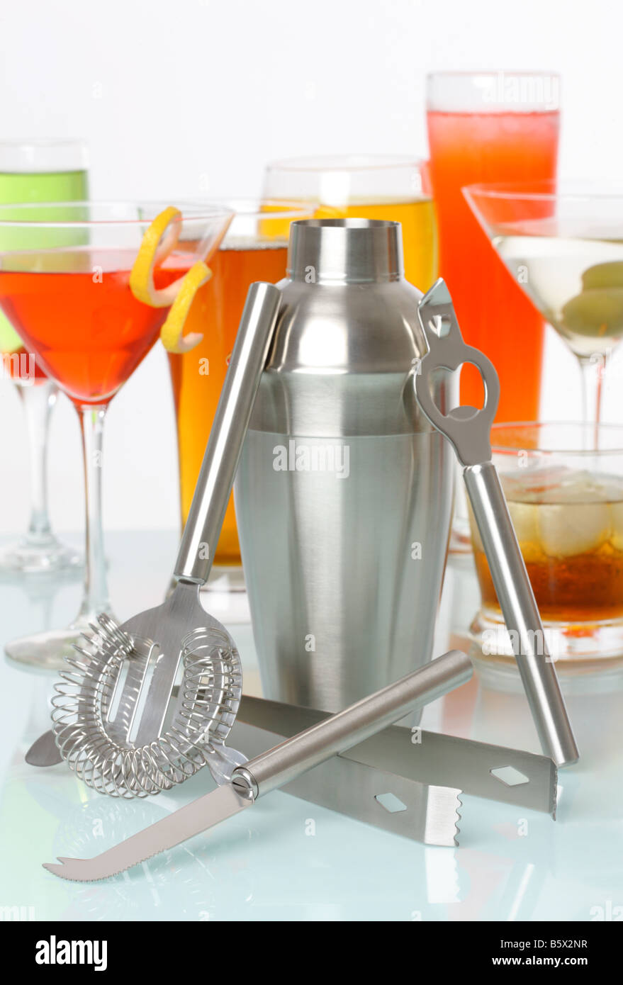 Bartending tools with a variety of drinks and cocktails in background Stock Photo