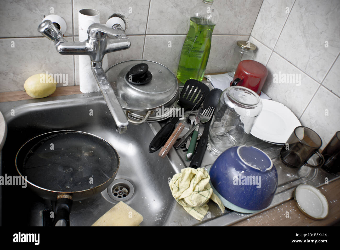 Kitchen sink full of dirty dishes Stock Photo Alamy
