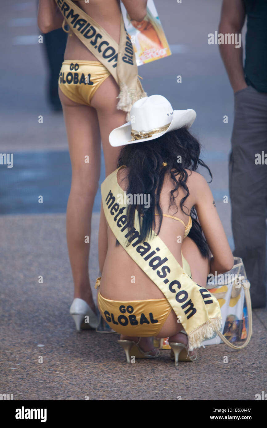rear view of two meter maids promotional girls dressed in gold coloured