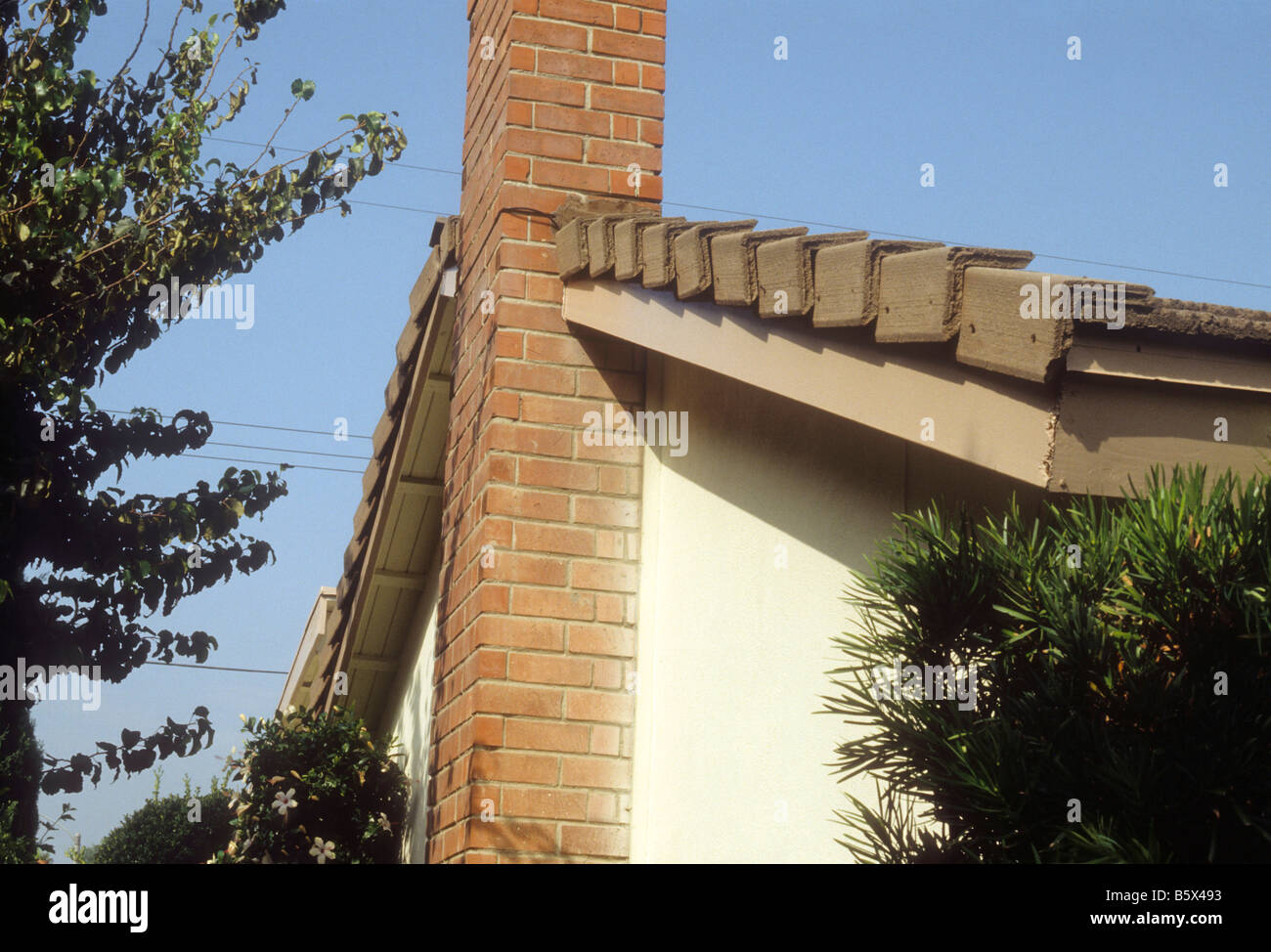 Concrete roof tiles cover surface and edge trim of house Stock Photo