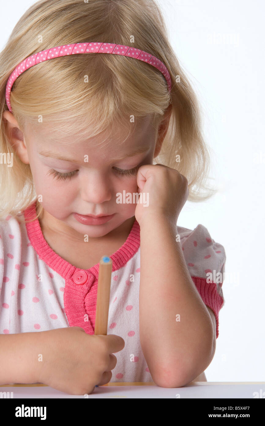 Little blond girl with a coloring pencil Stock Photo - Alamy