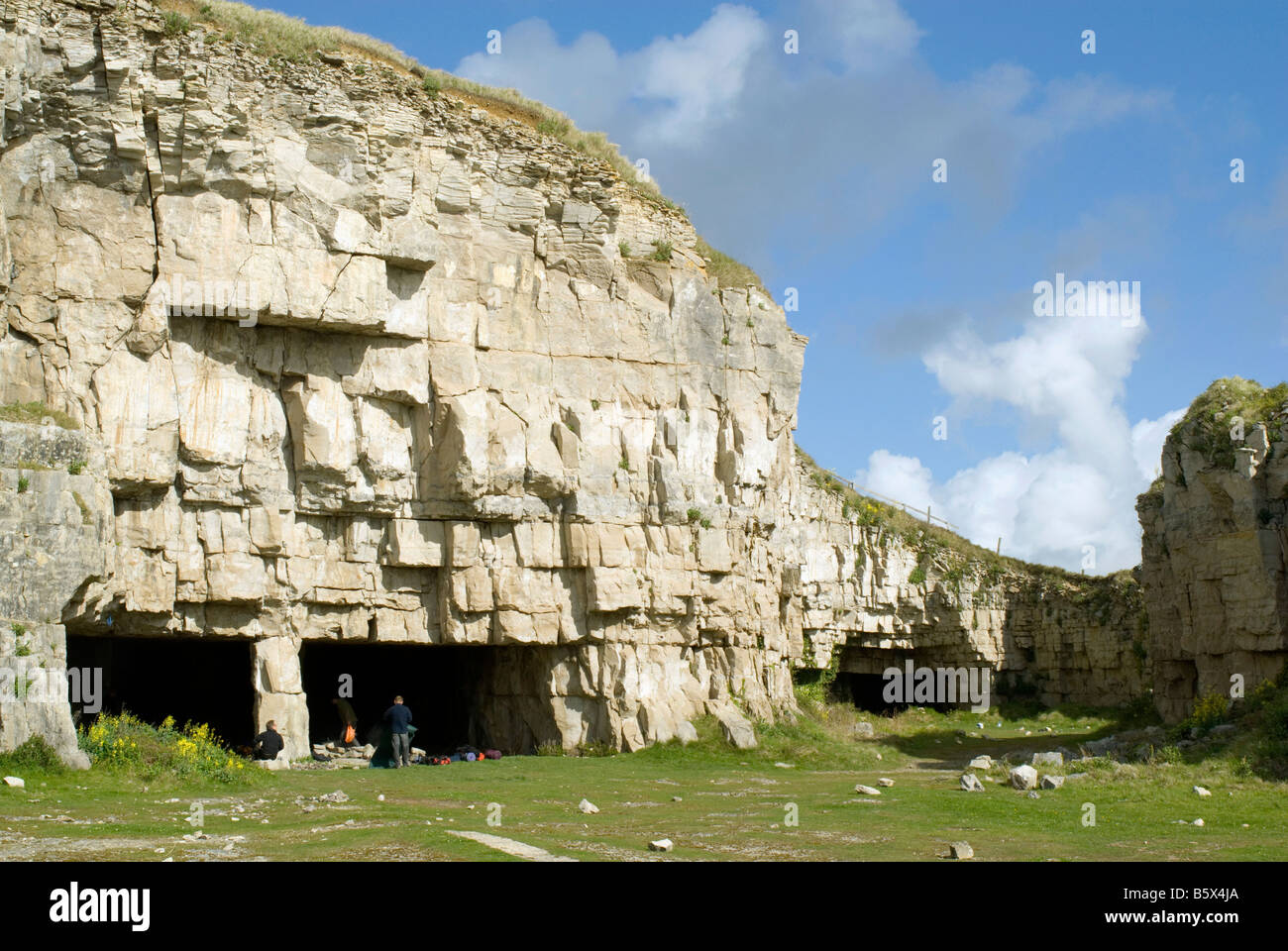 Caves at the foot of cliffs at Winspit Quarry on the Dorset coast Stock