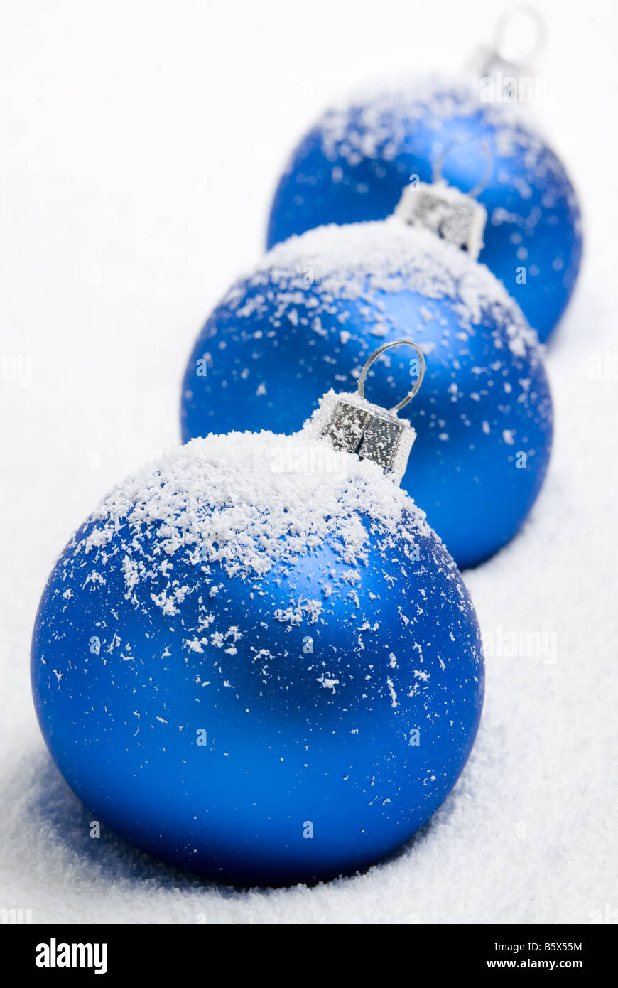 Blue christmas balls lying on the snow, aRGB. Stock Photo