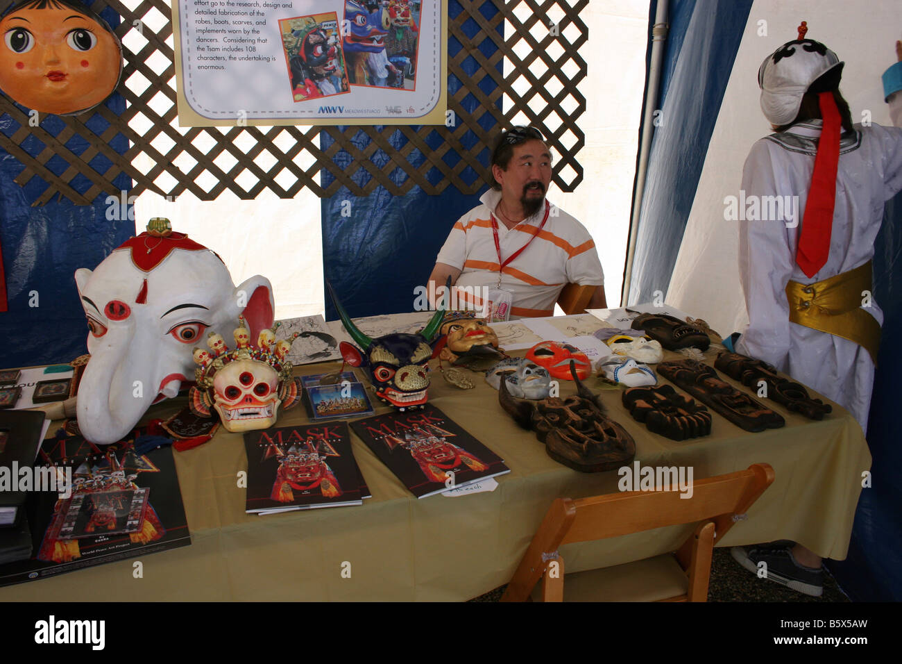 Artisans of the Mongolian GooErtunts Society selling  Ink paintings on rice paper and Mongolian masks at folk festival. Stock Photo