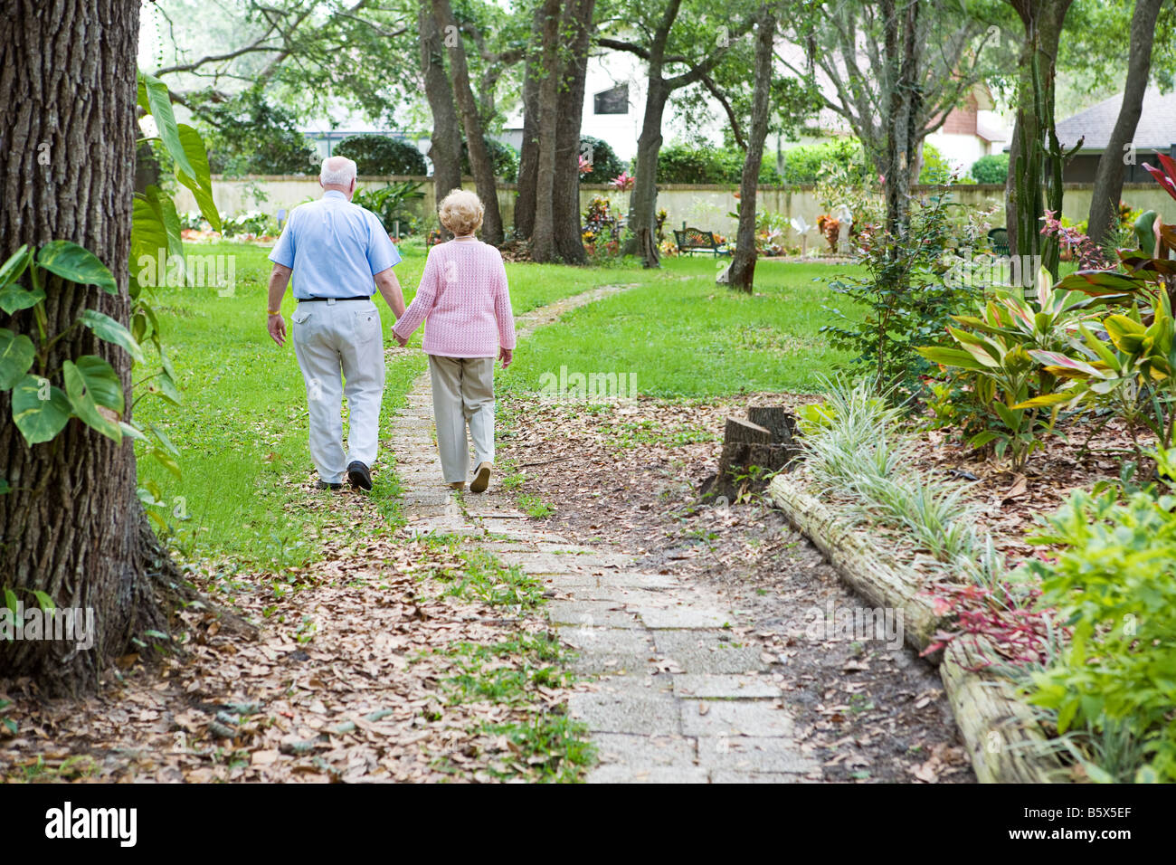Senior couple strolling down a garden path together A metaphore for ...