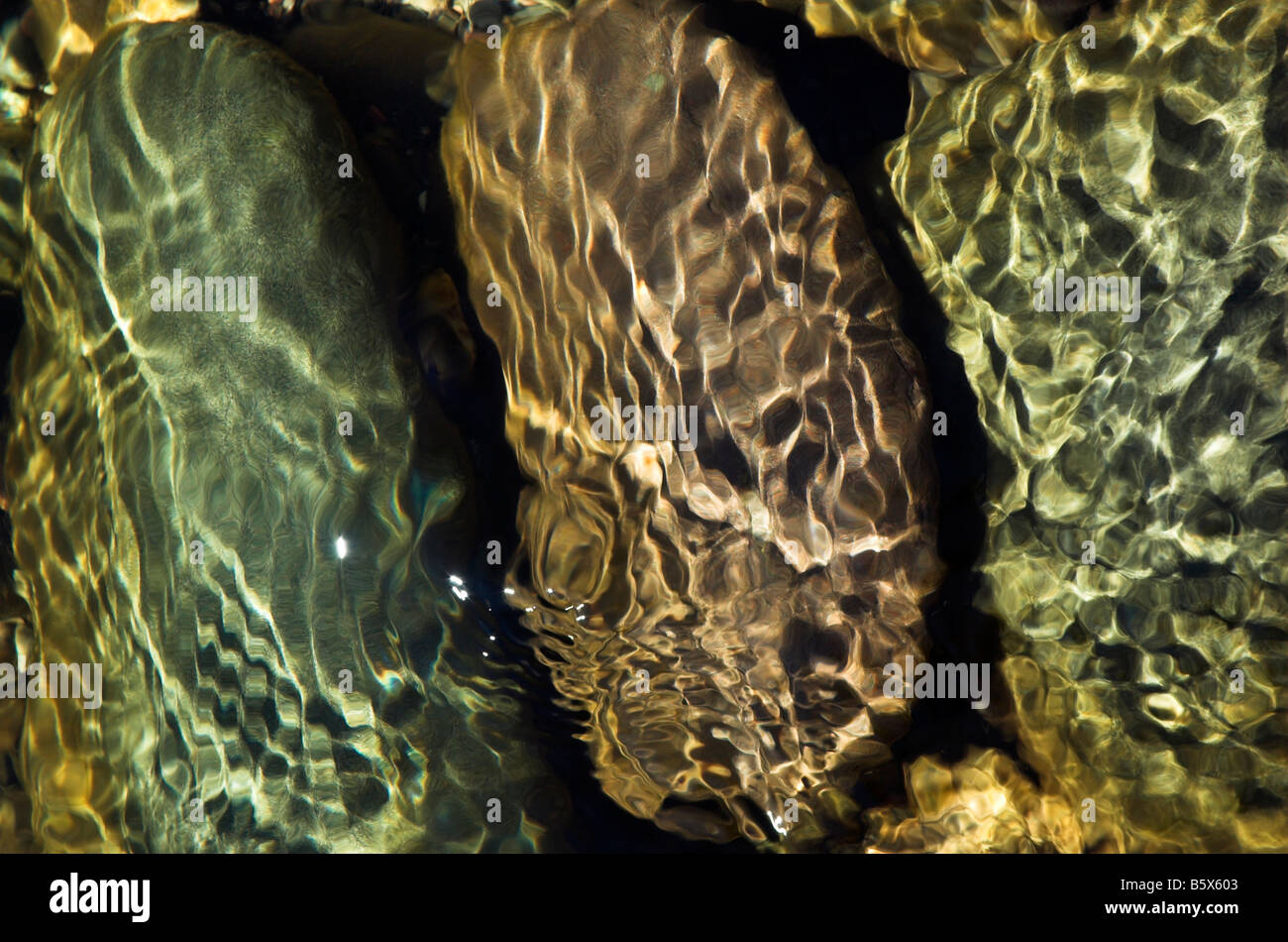 Dappled sunlight on rocks underwater Stock Photo