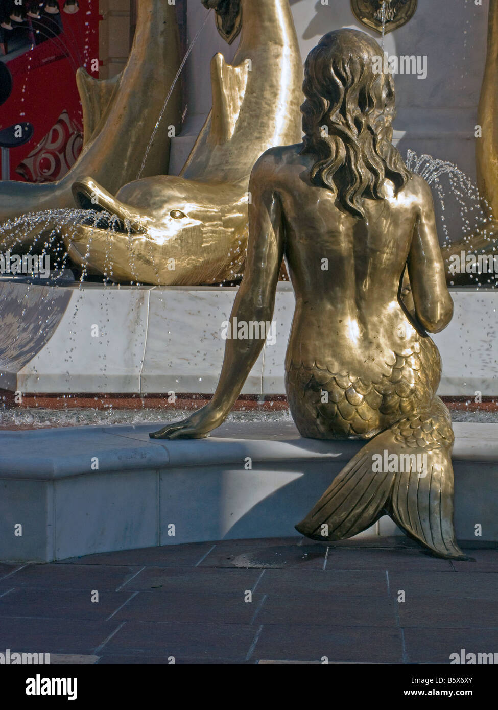 Mermaid & dolphin in Barton Square shopping centre water fountain feature, part of Trafford Park shopping complex, Manchester Stock Photo