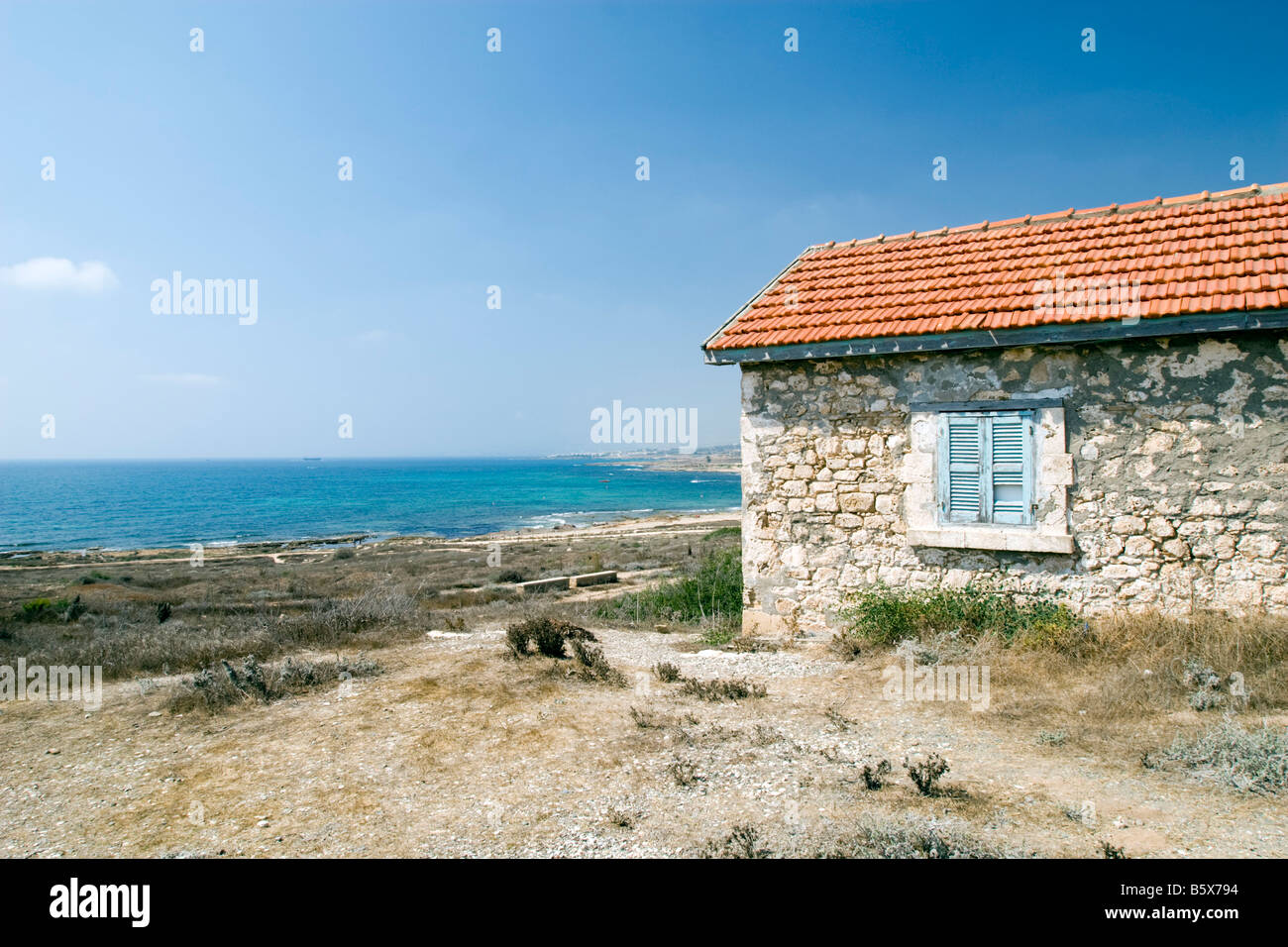 Paphos seascape with orange roof stone tiled house Stock Photo