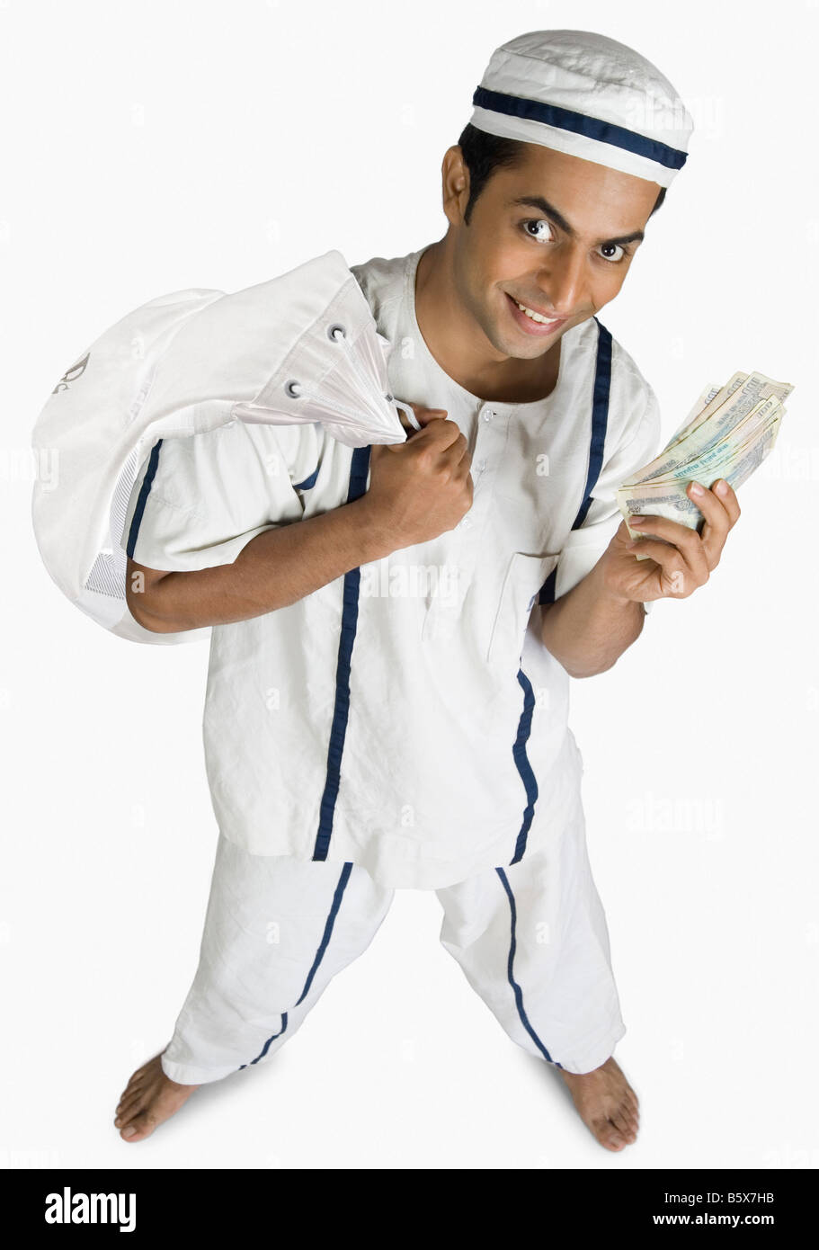 Portrait of a prisoner carrying a bag and showing paper currency Stock Photo