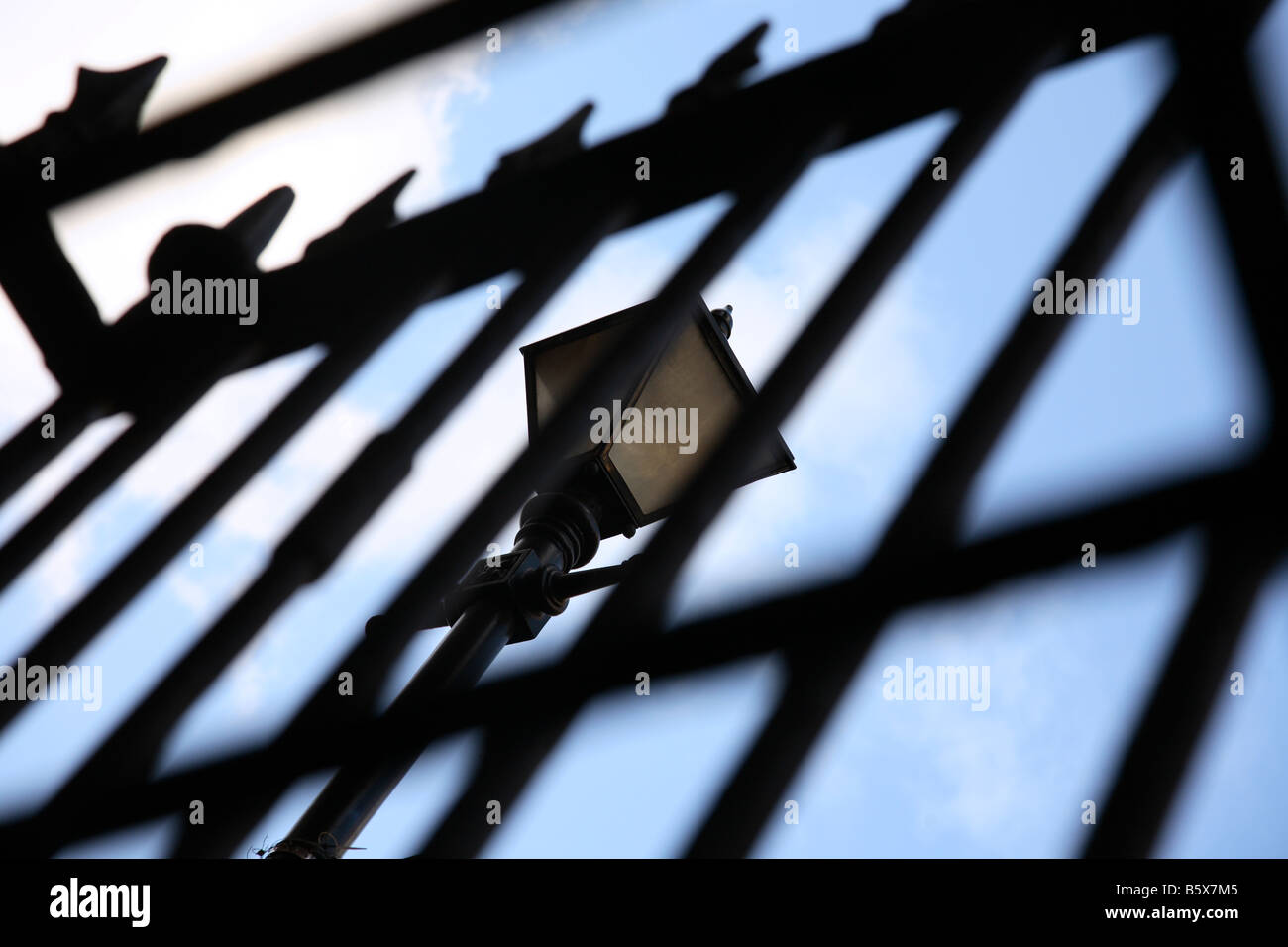 Old gas street lamp seen through railings in London Stock Photo Alamy
