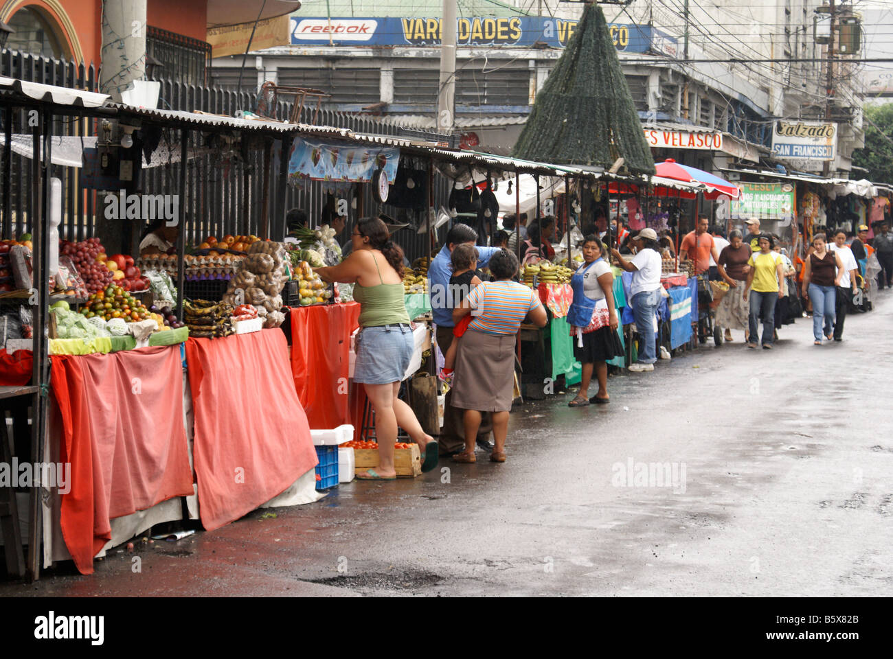 Fruit and produce stalls lining a street in downtown San Salvador, El