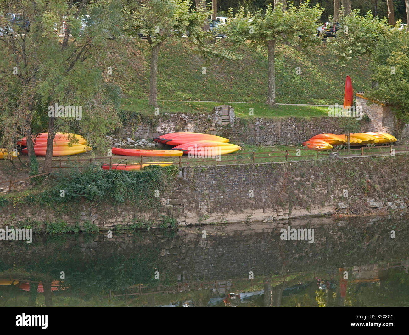 canoes on riverbank Aveyron with reflection Saint Antonin Noble Val