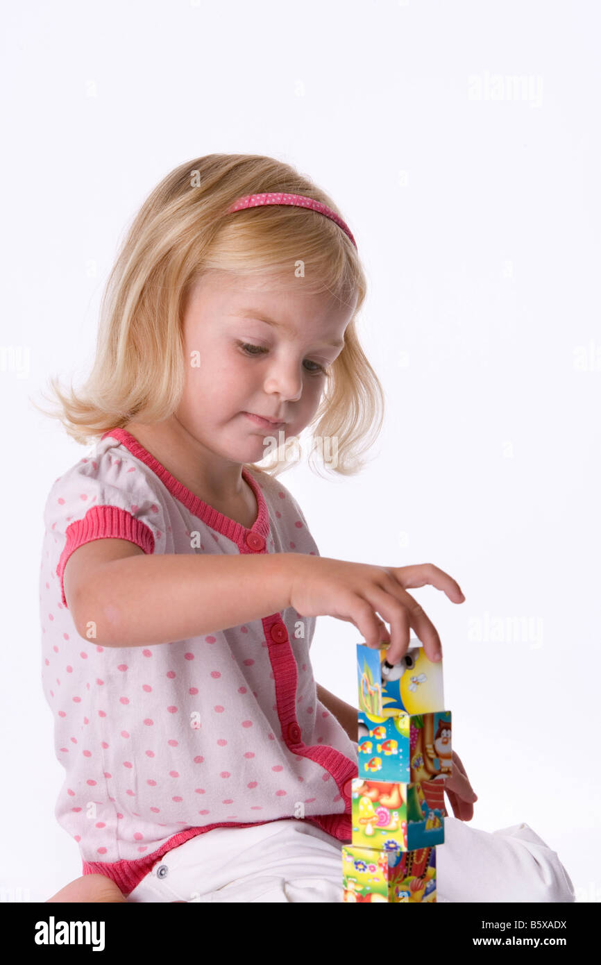 Llittle blond girl playing with bricks Stock Photo