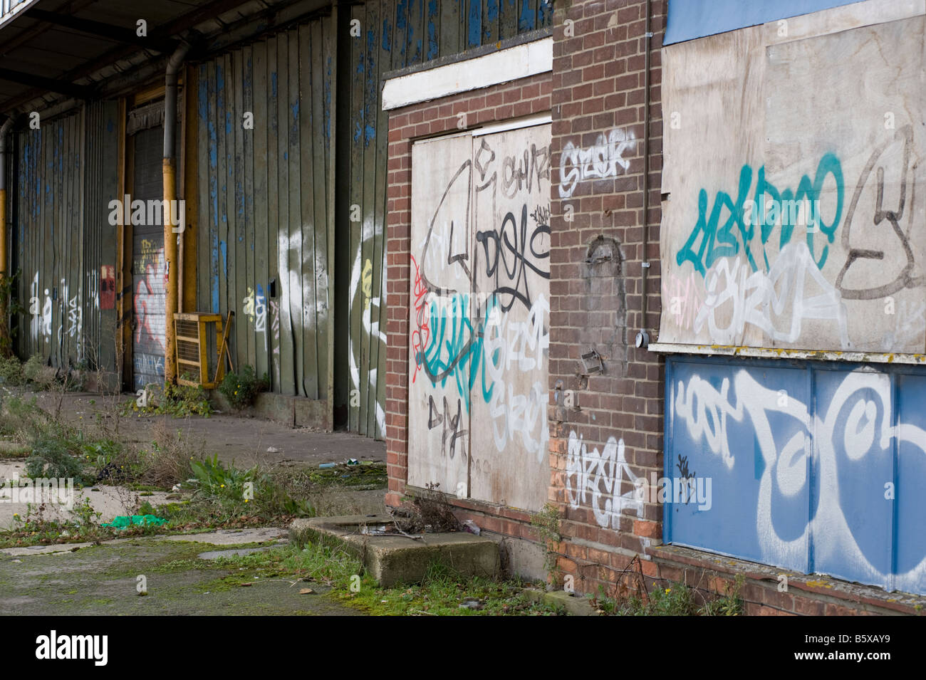 Vandalized abandoned dock buildings at the Hythe, Colchester, Essex, UK. Stock Photo