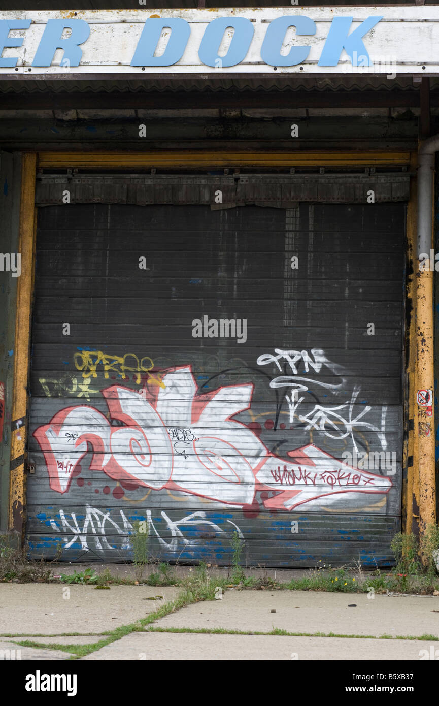 Vandalized abandoned dock buildings at the Hythe, Colchester, Essex, UK. Stock Photo