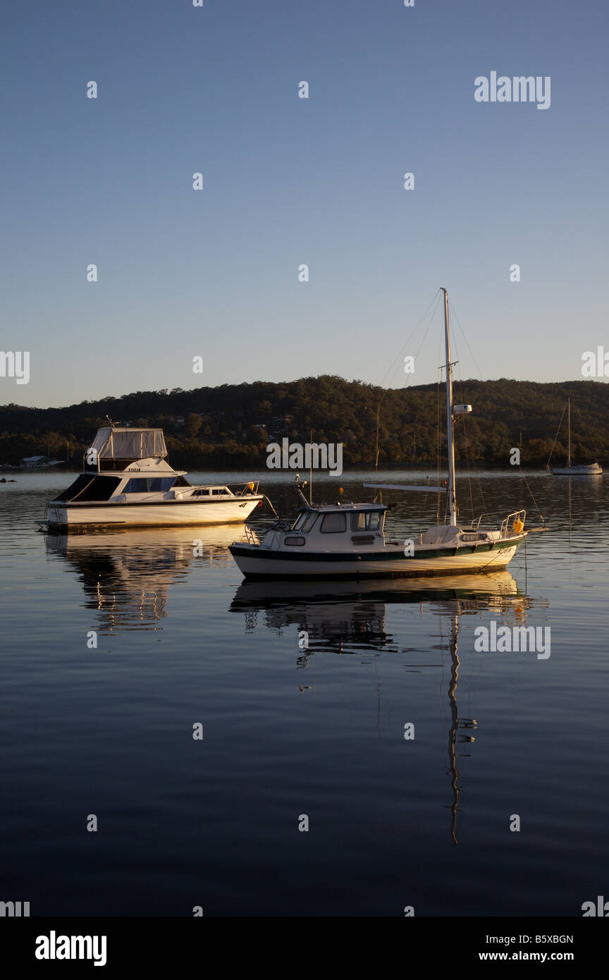 Boats moored on Brisbane Water, looking across the bay from Gosford to Tascot, NSW Australia Stock Photo
