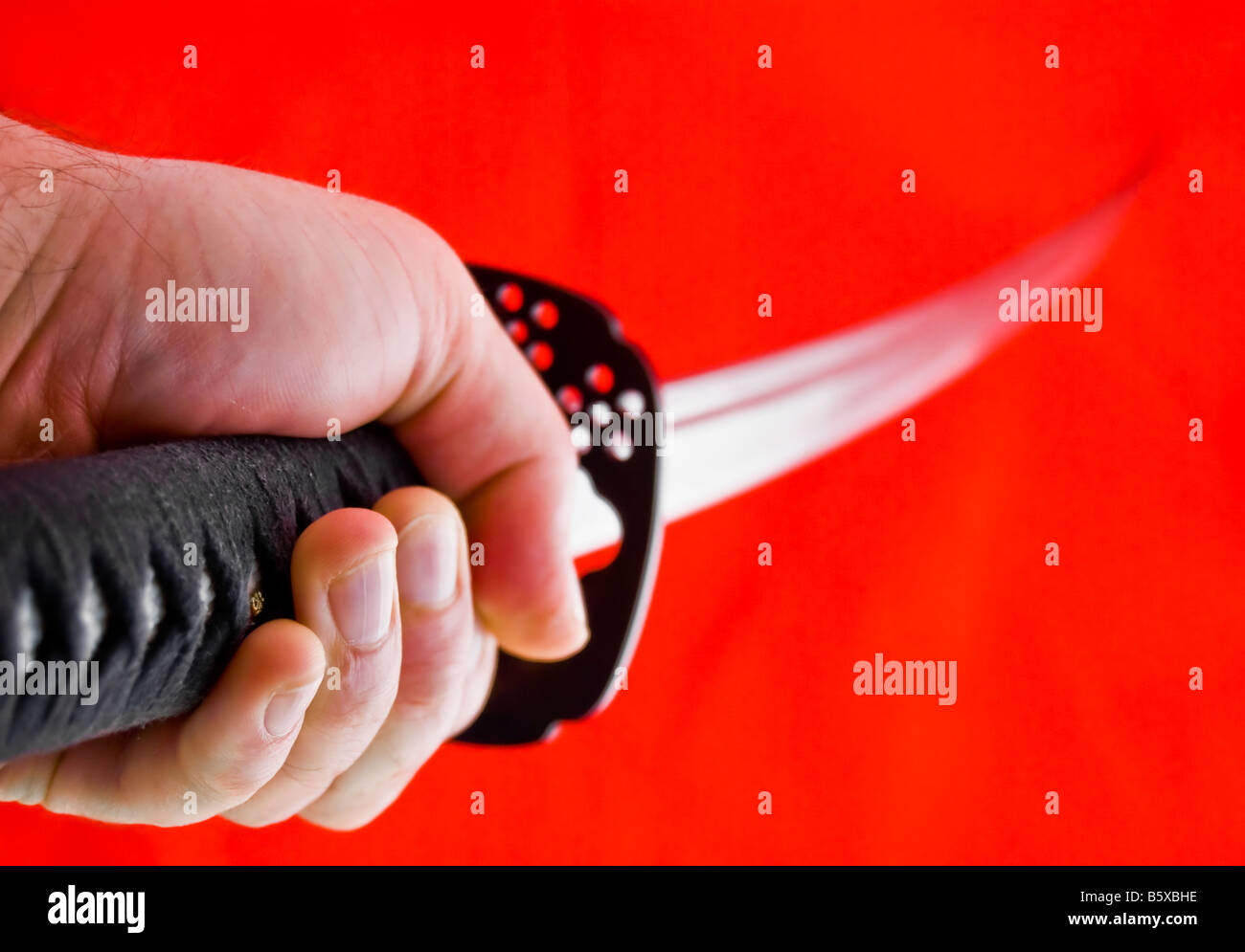 Man's hand holding Japanese sword katana Stock Photo