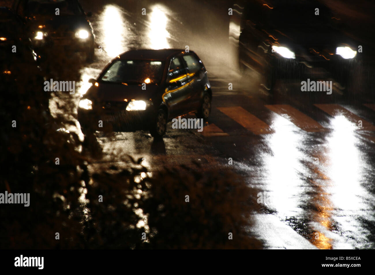 fast car driving in heavy rain at night in town Stock Photo - Alamy