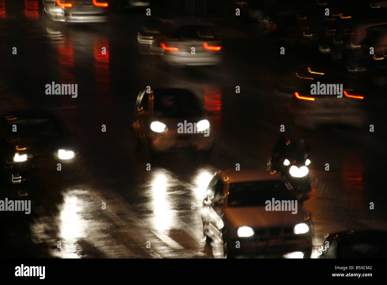 fast cars driving in heavy rain at night in town Stock Photo - Alamy