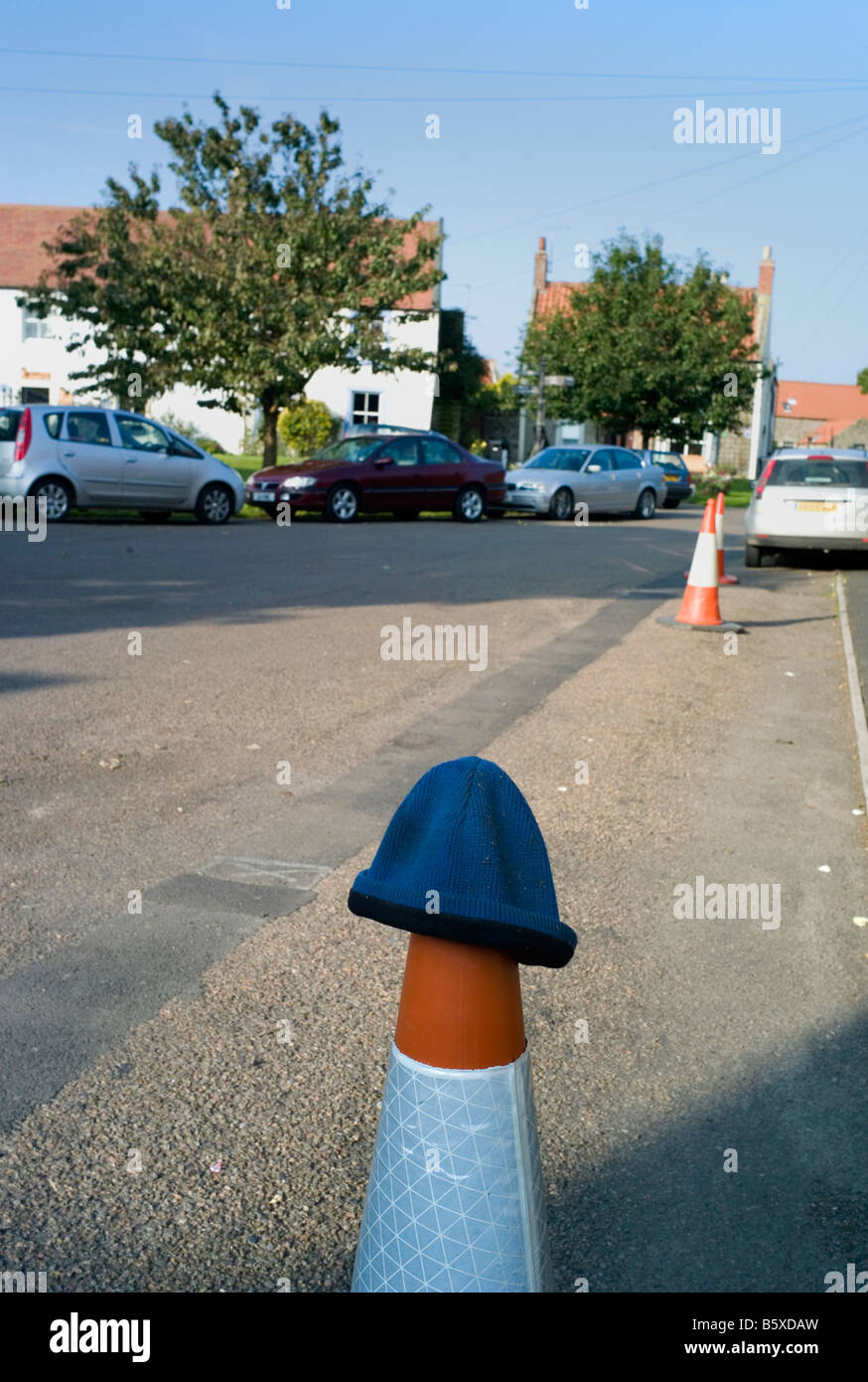 Lost woolly hat on a traffic cone Stock Photo