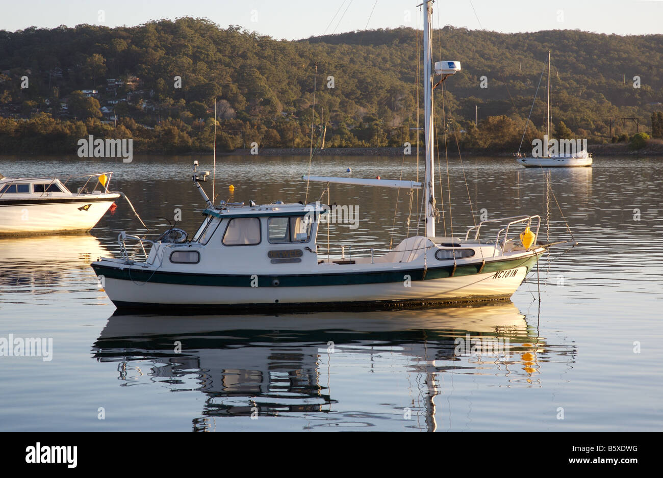 Wooden Boat moored on Brisbane Water, looking across the bay from Gosford to Tascot, NSW Australia Stock Photo