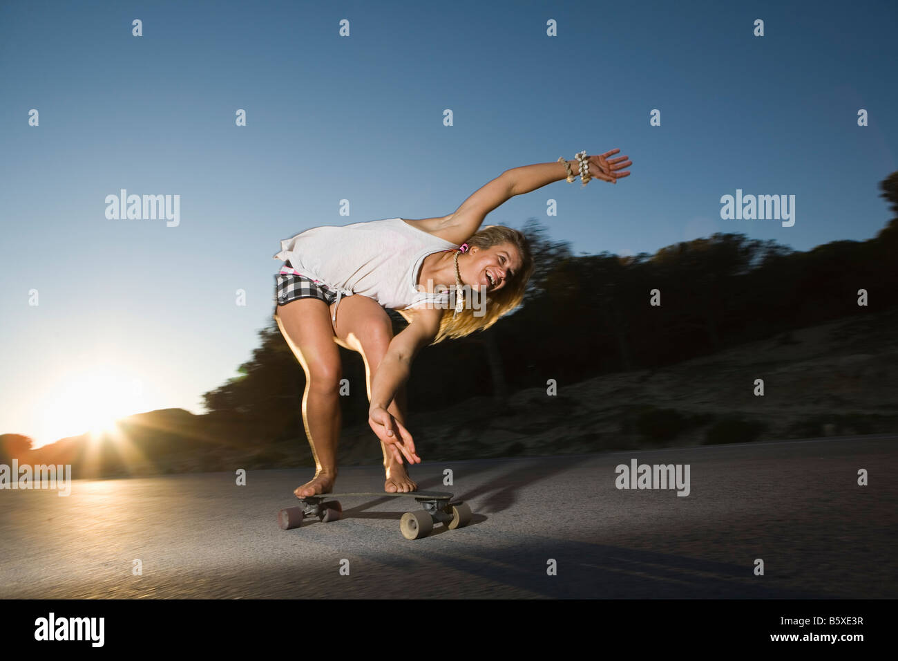 Young woman on skateboard Stock Photo