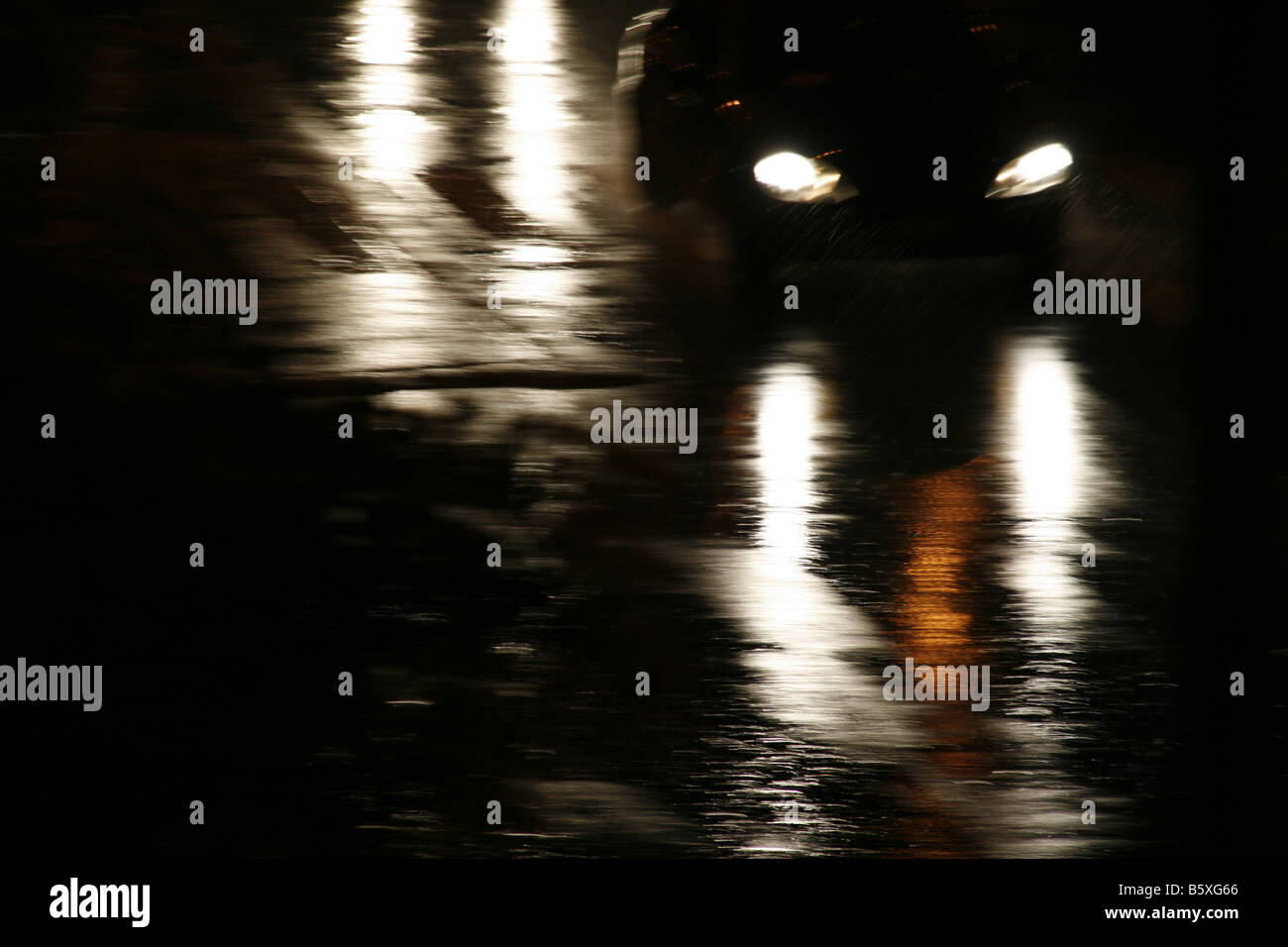 fast car driving in heavy rain at night in town Stock Photo